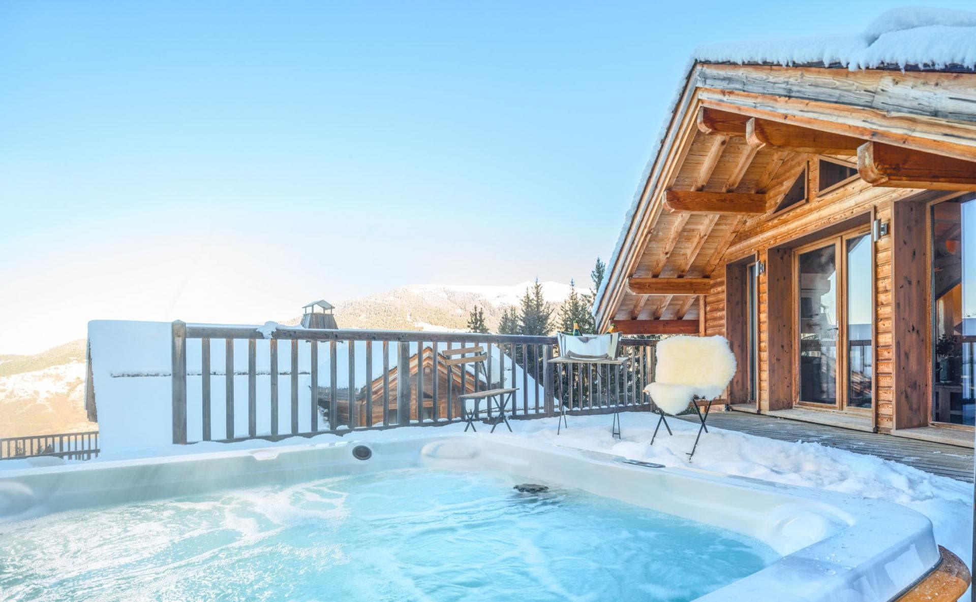 Outdoor hot tub on private deck with mountain views