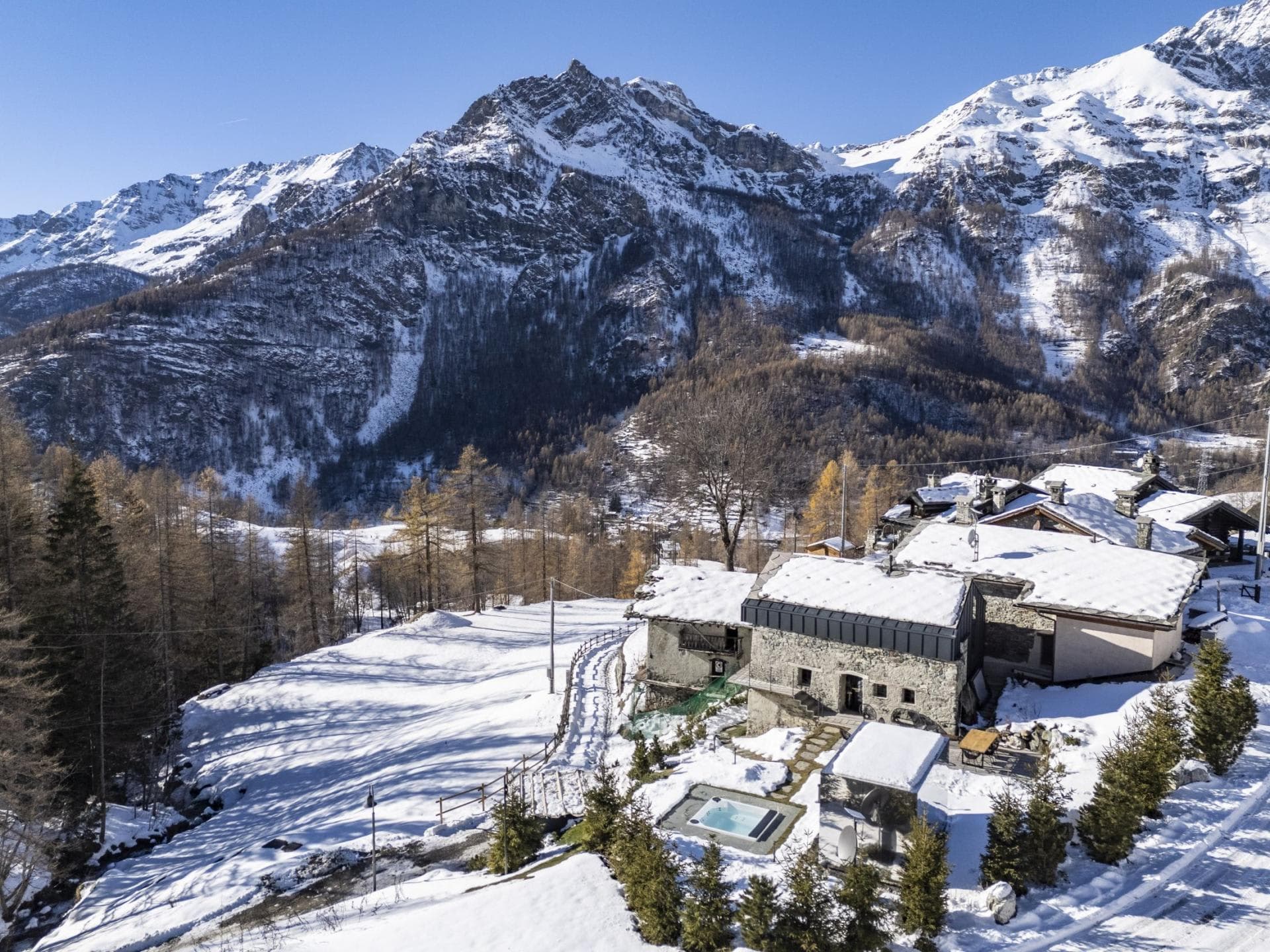 Stone chalet with outdoor hot tub and panoramic Alpine mountain views