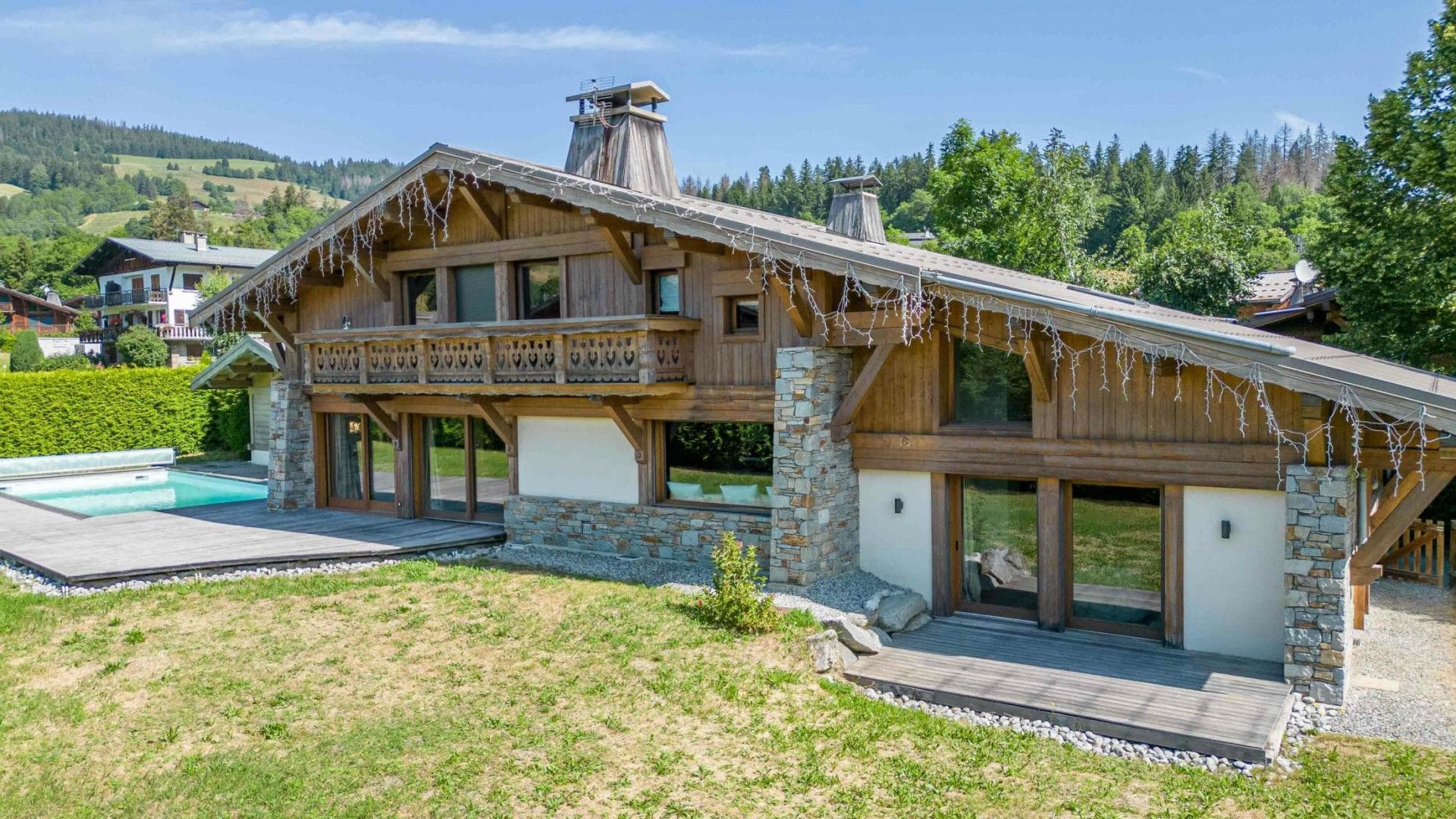 Chalet exterior with ground-floor terrace and private heated pool
