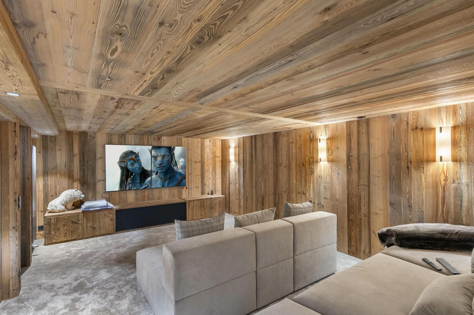 Media room with wood-paneled walls and modular sectional seating