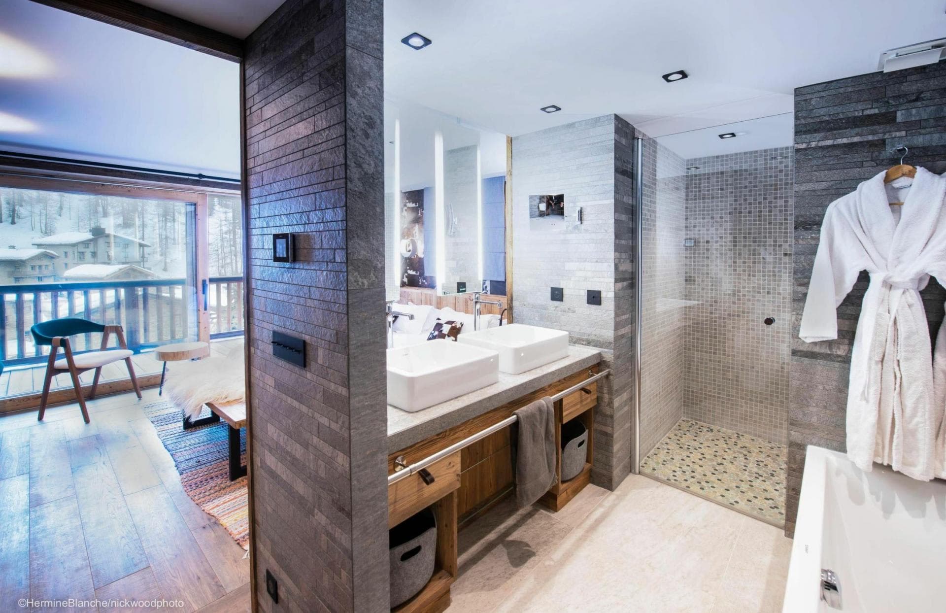 Ensuite bathroom with dual vanity, walk-in shower, and private balcony access