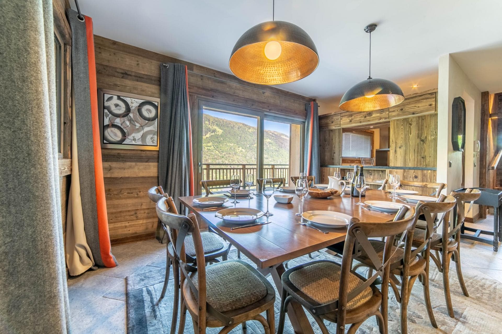Dining area seats 10 with mountain views and balcony access