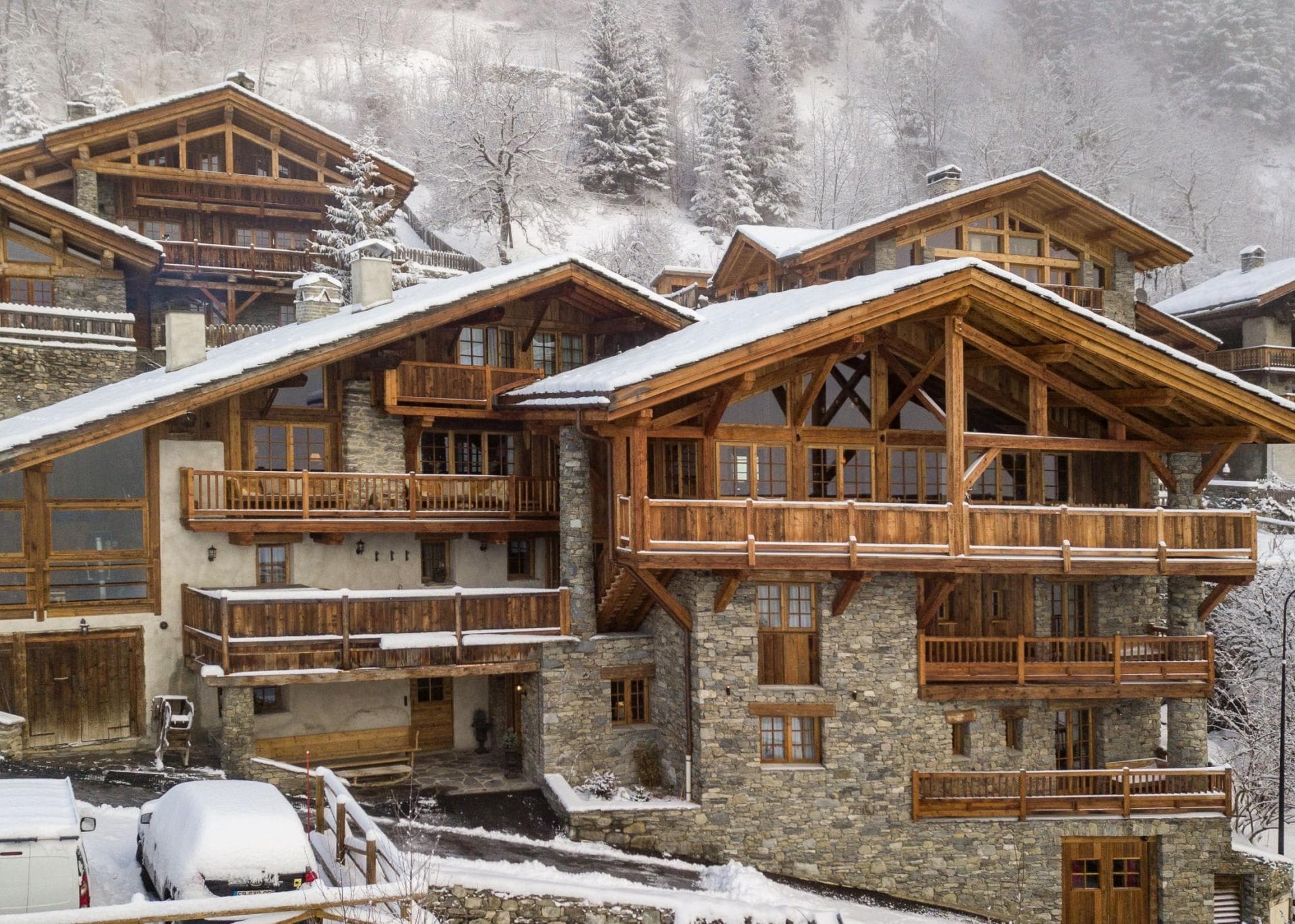 Stone and timber chalet with multiple private balconies and driveway parking