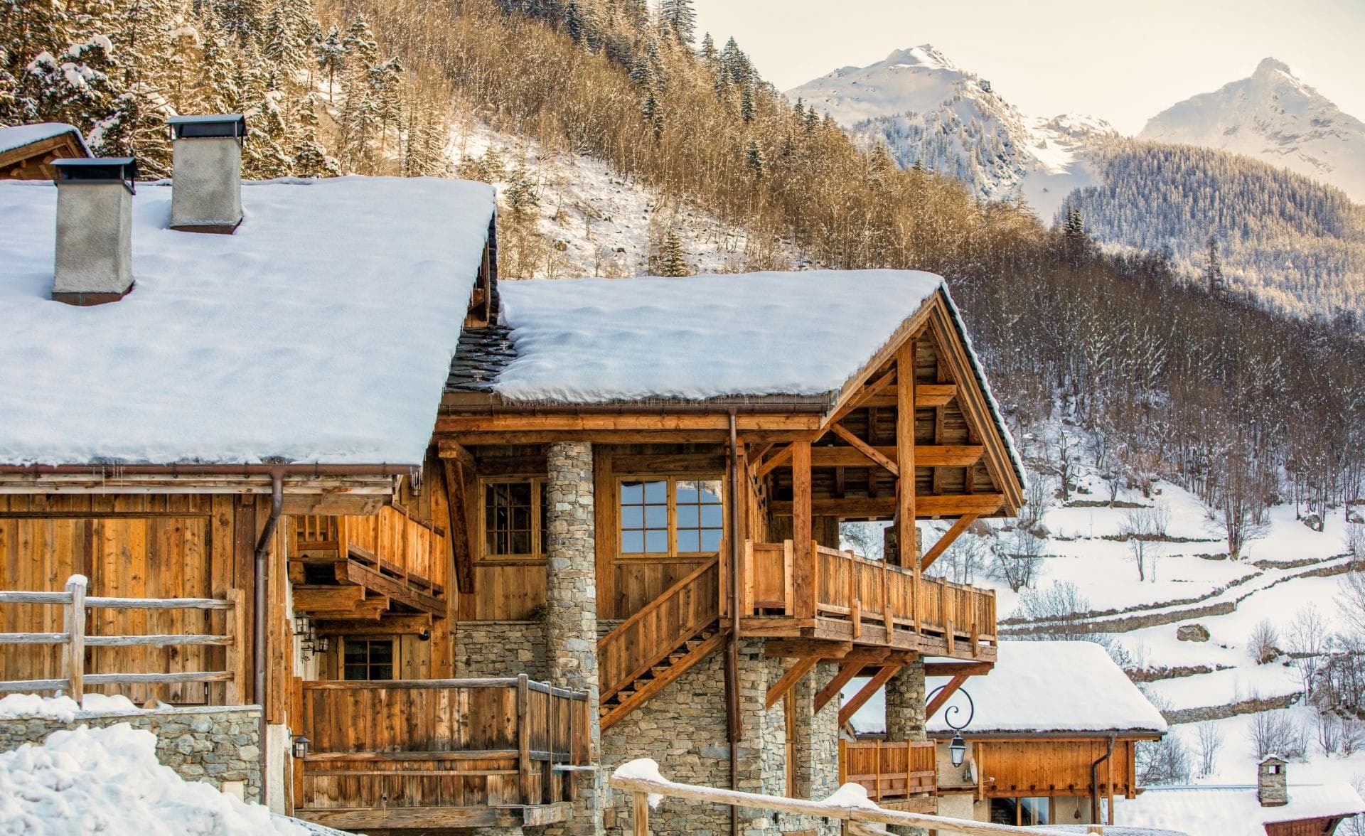 Chalet exterior with multiple private balconies and mountain views