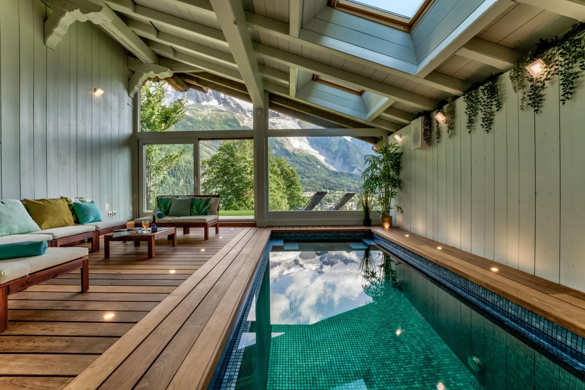 Indoor pool with skylights, wood decking, and Mont Blanc mountain views