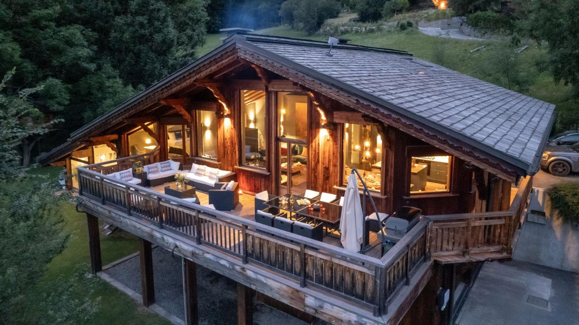 Elevated terrace with lounge seating, 8-person dining table, and gas grill