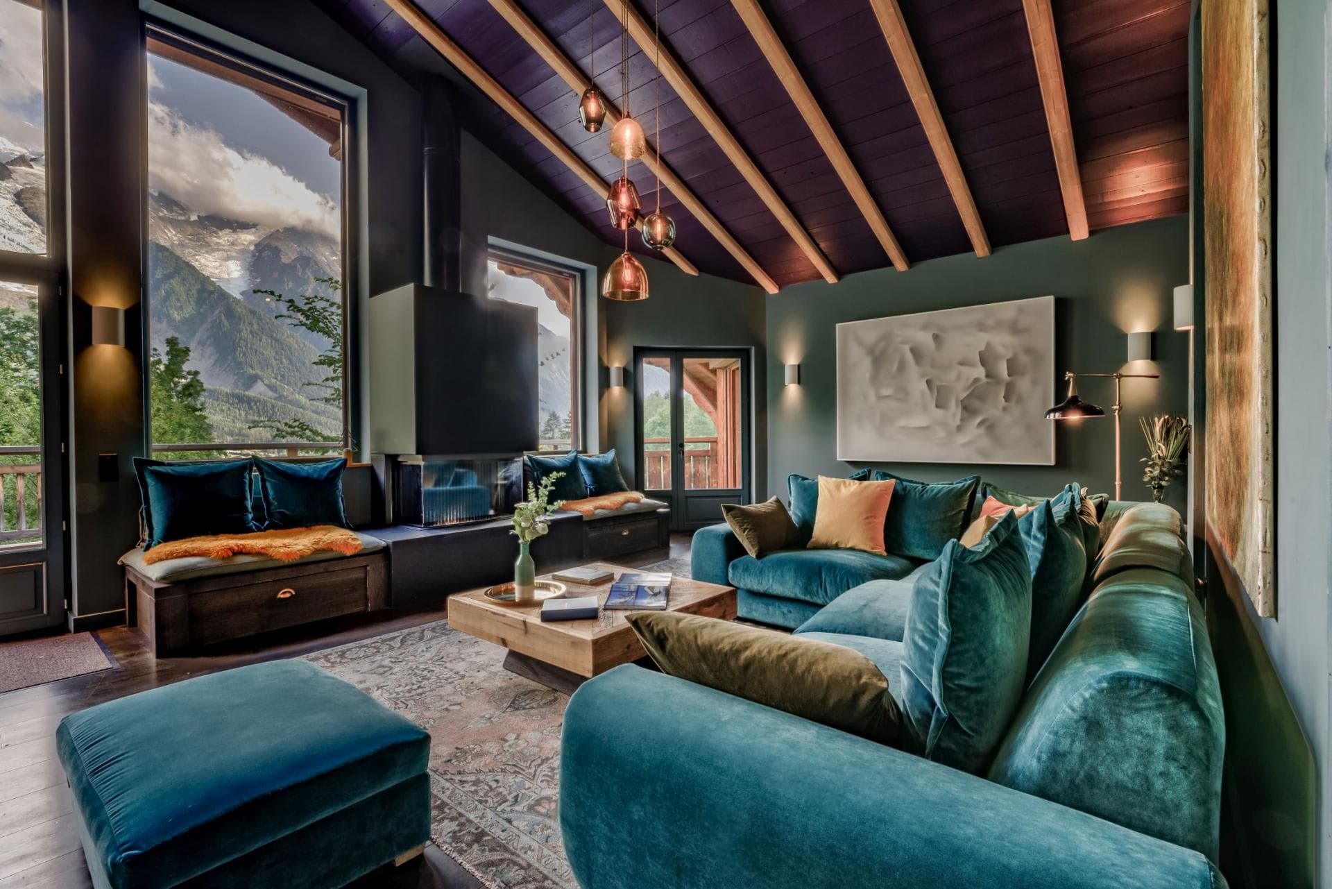 Living area with wood-burning fireplace and mountain-view window seating