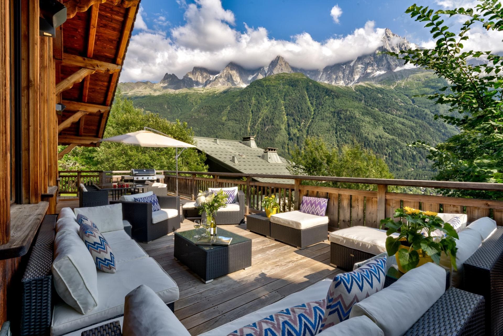 Wooden deck with sectional seating and gas grill; Mont Blanc views