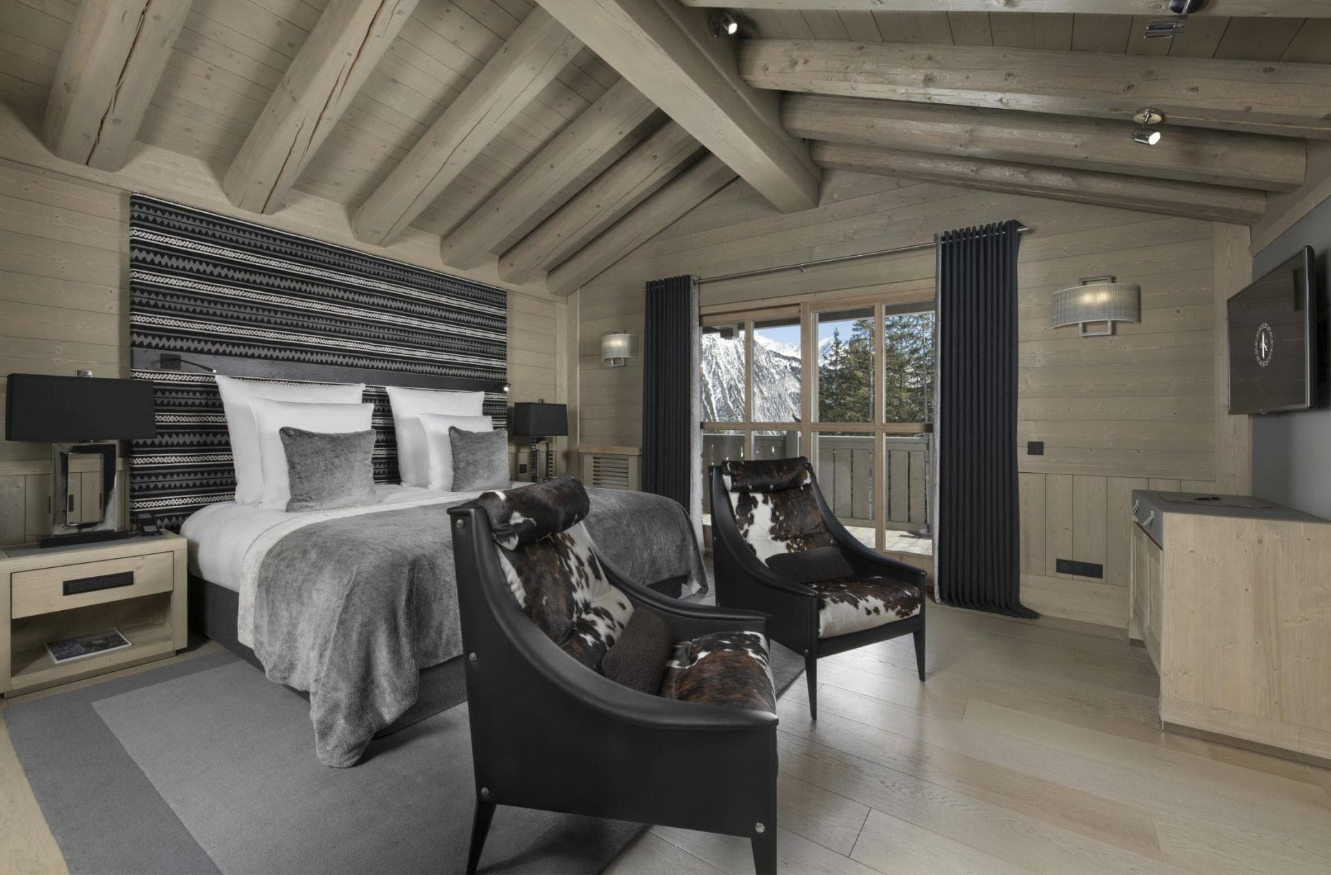 Primary bedroom with king bed, mountain views, and heated black curtains