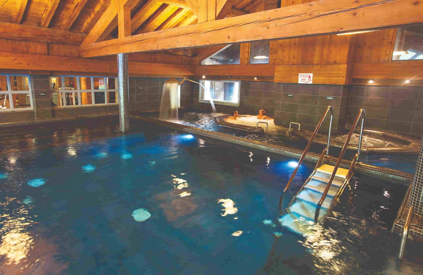 Indoor heated pool and hot tub with waterfall feature