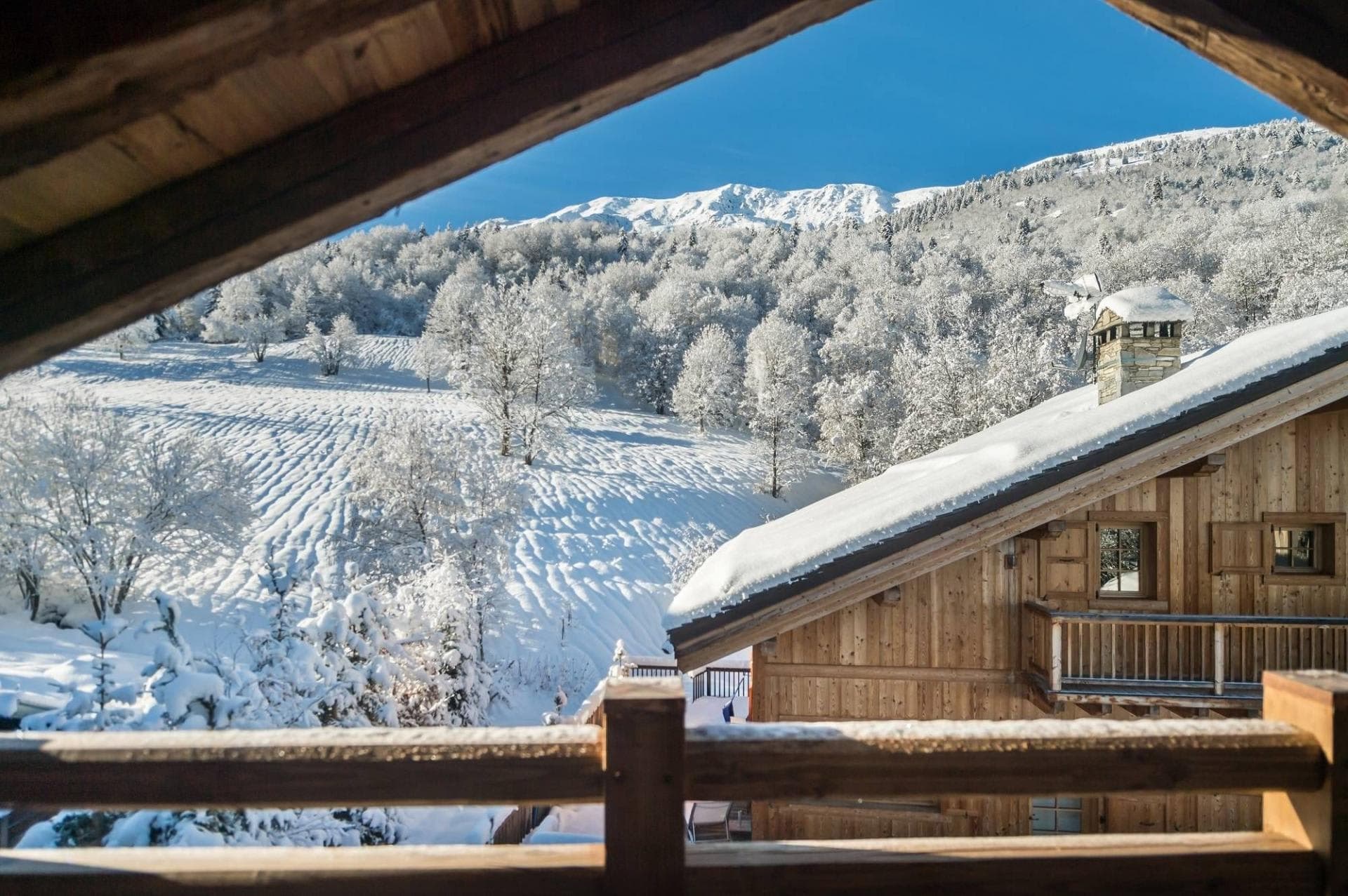 Private balcony view of snow-covered valley and mountain peaks