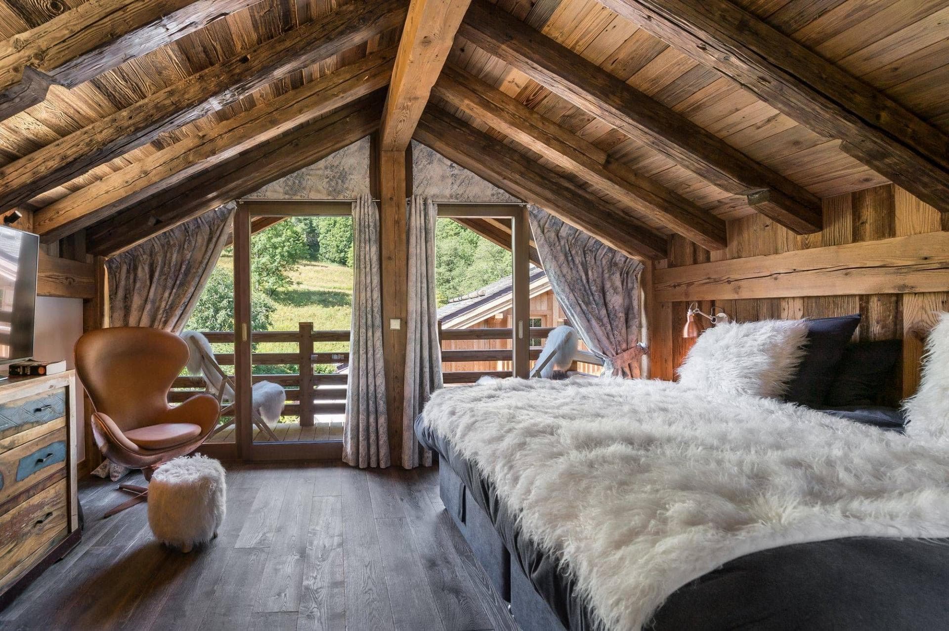 Attic bedroom with king bed and private balcony access