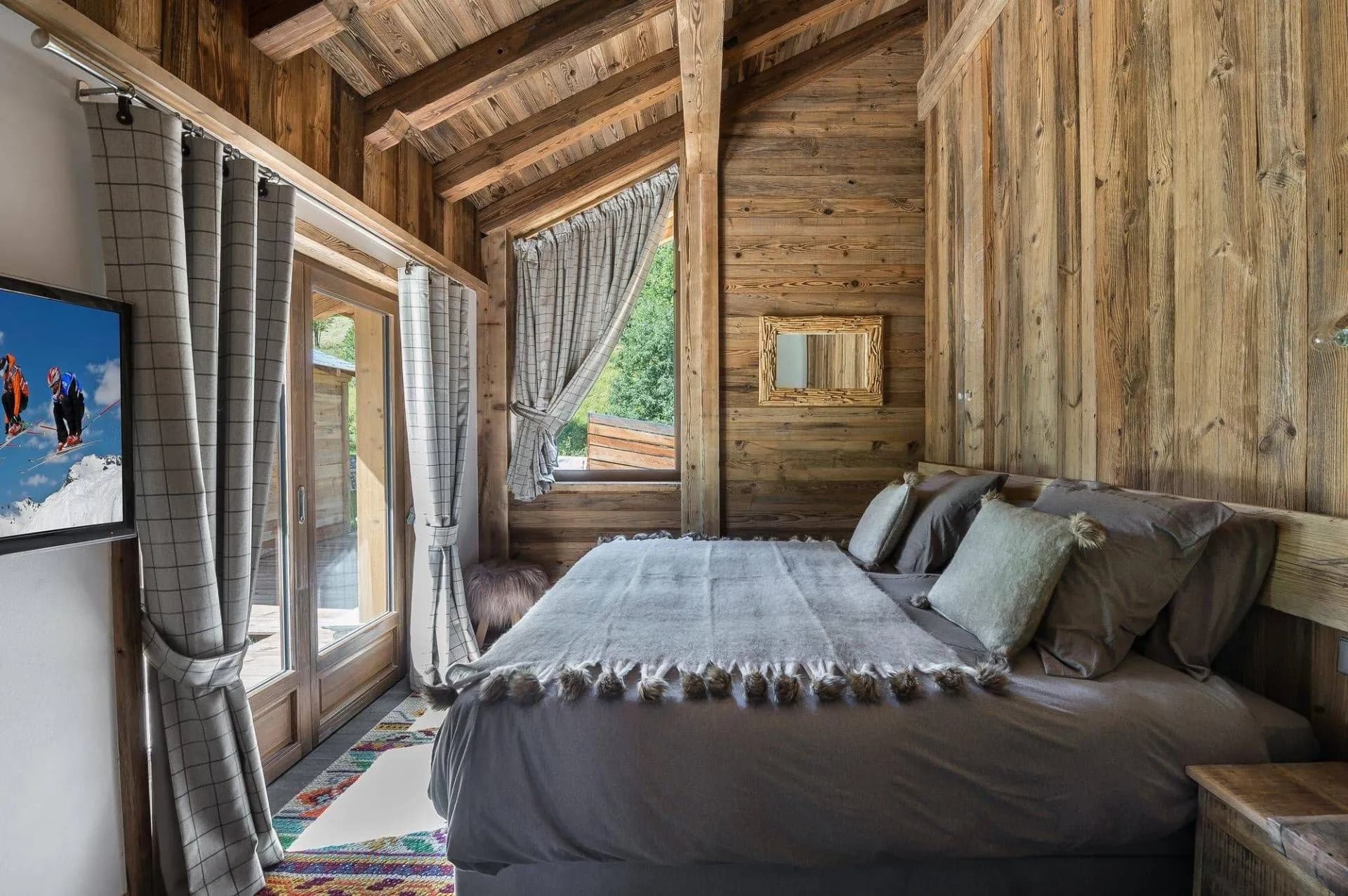 Double bedroom with balcony doors and television