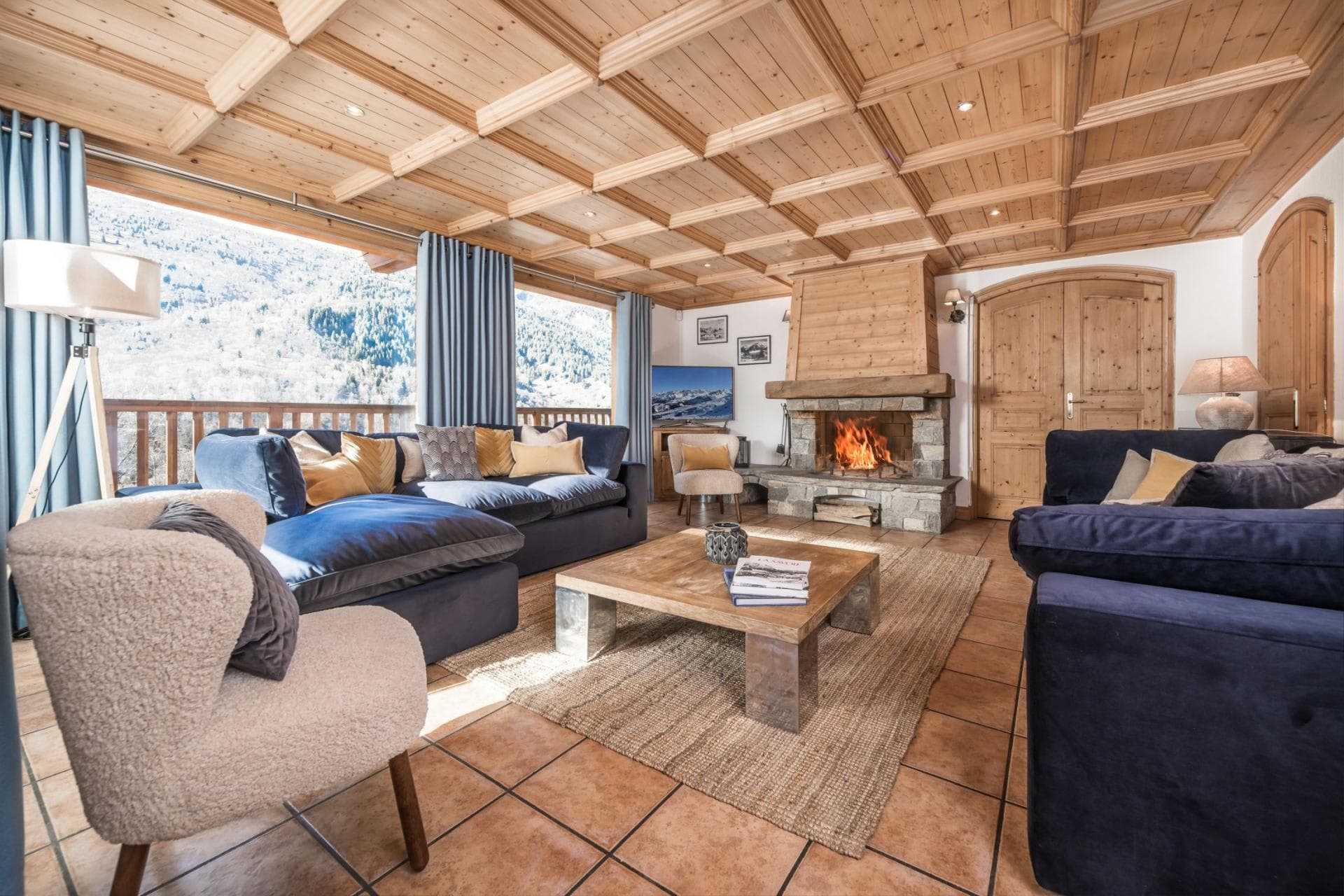 Living area with wood-burning fireplace and mountain-view balcony