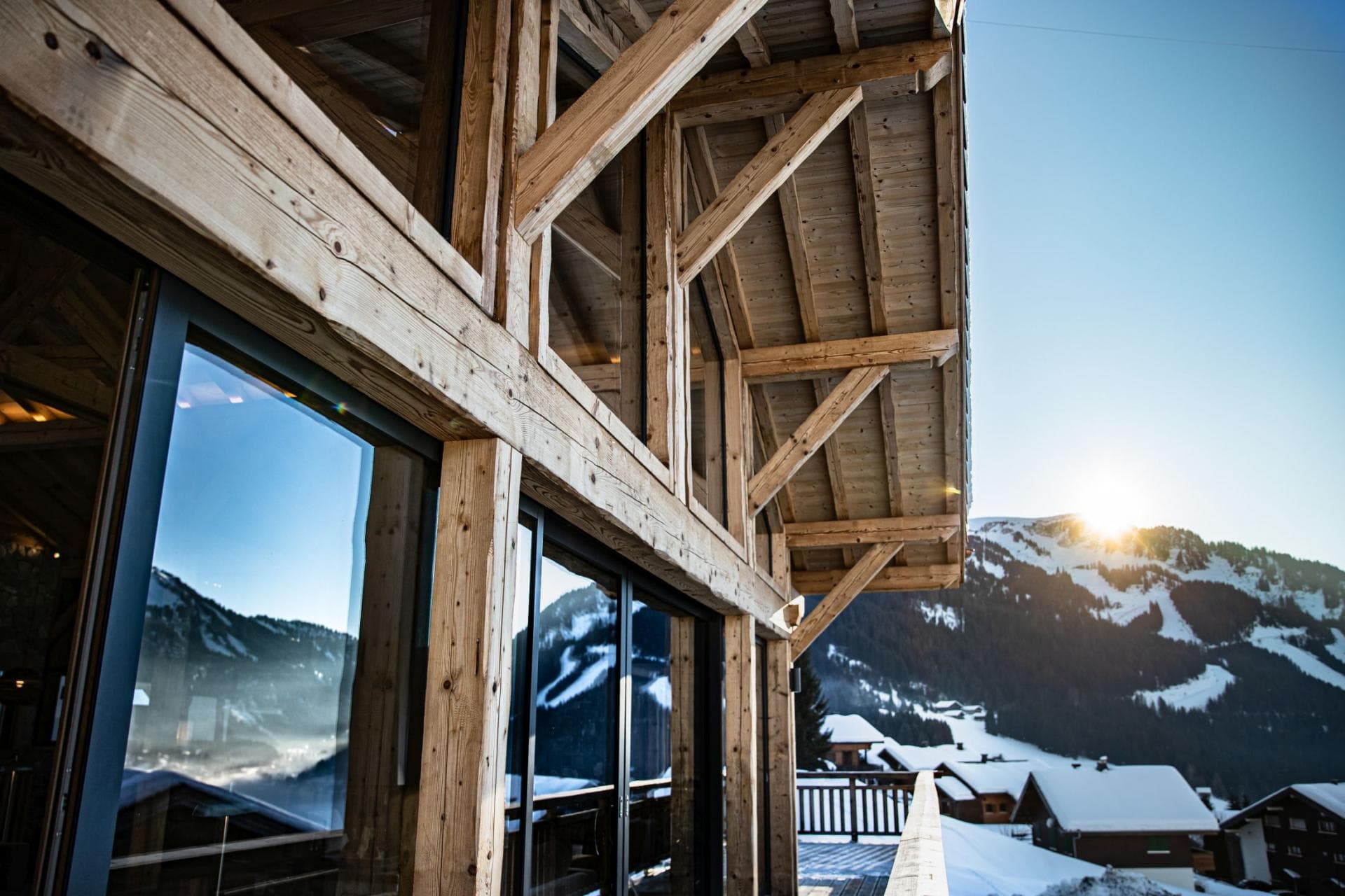 Timber-framed balcony with sunset views over ski slopes