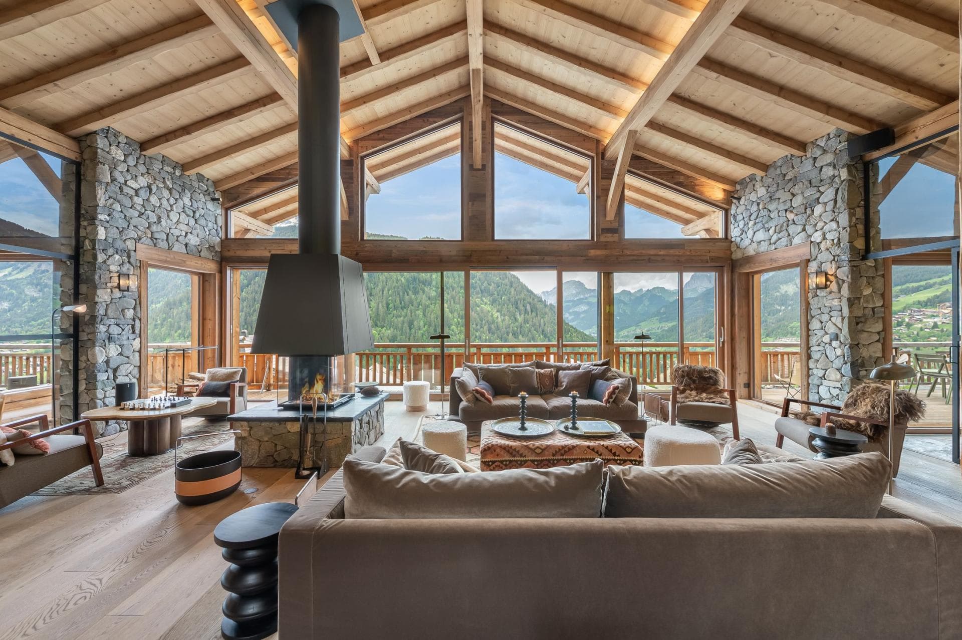 Living area with 360-degree fireplace and panoramic mountain views