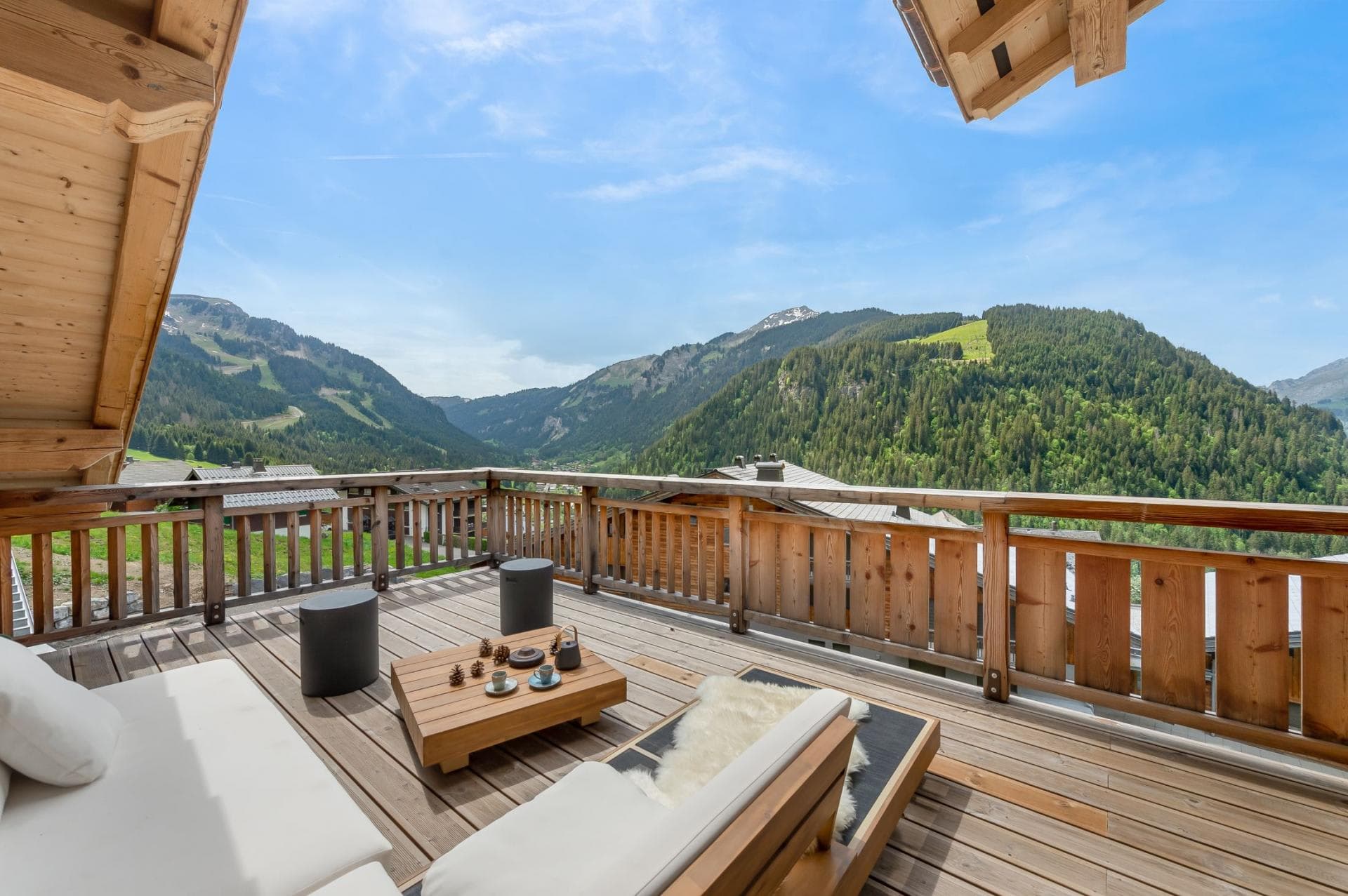 Private balcony with lounge seating and panoramic alpine valley views