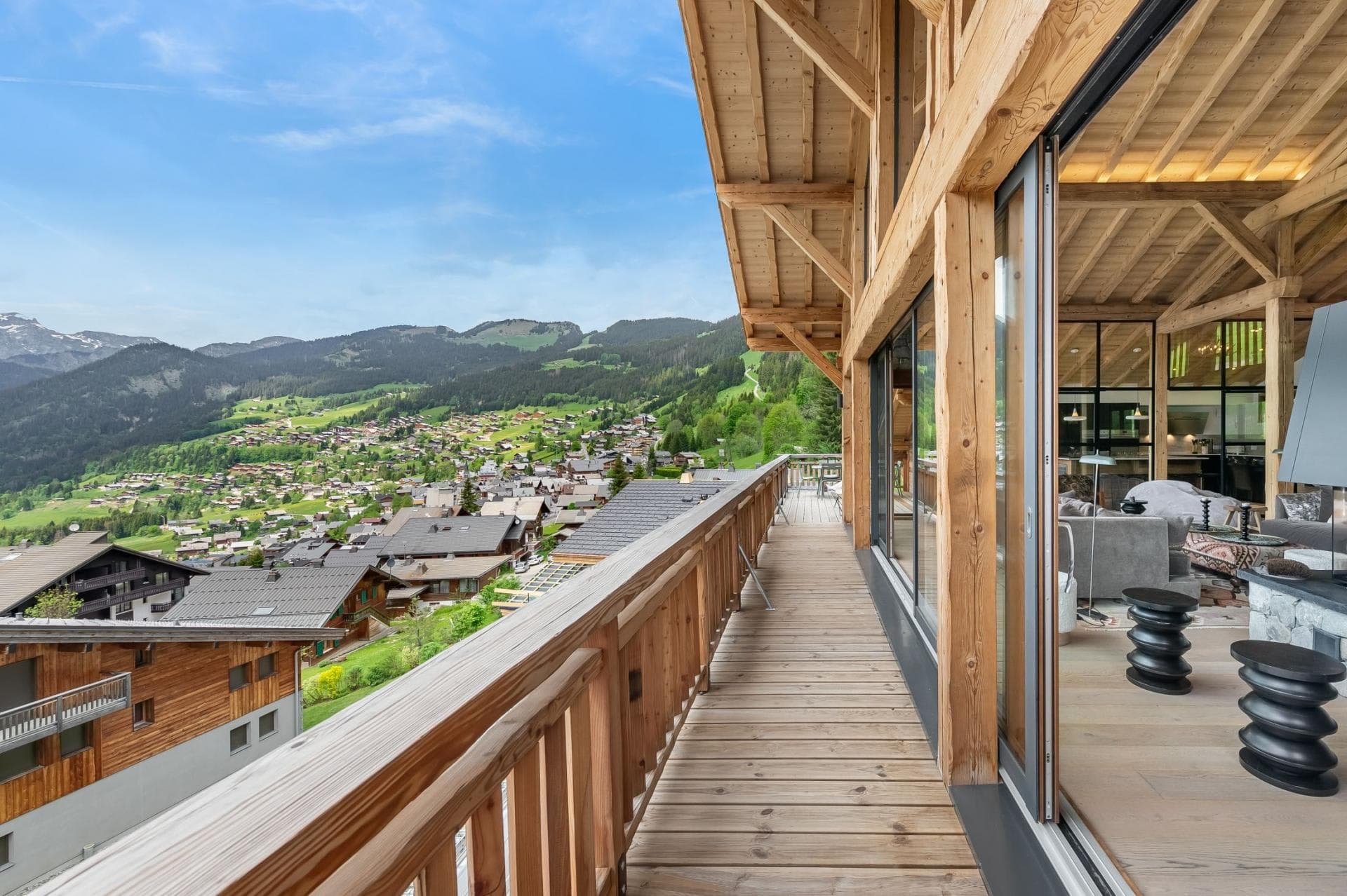 Timber-framed balcony with valley views and sliding glass door access