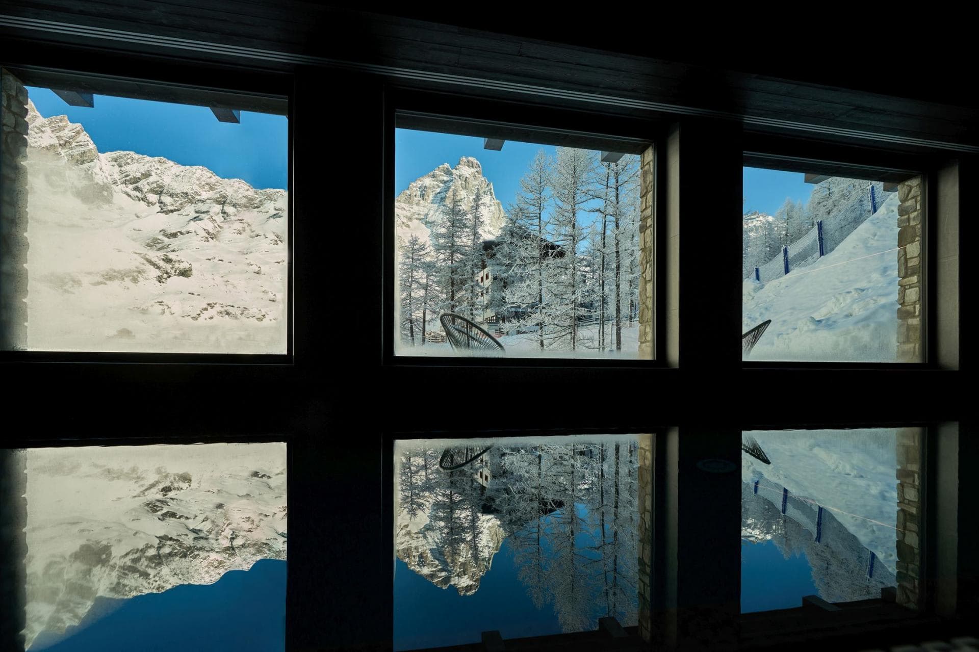 Indoor heated pool with mountain views and floor-to-ceiling windows