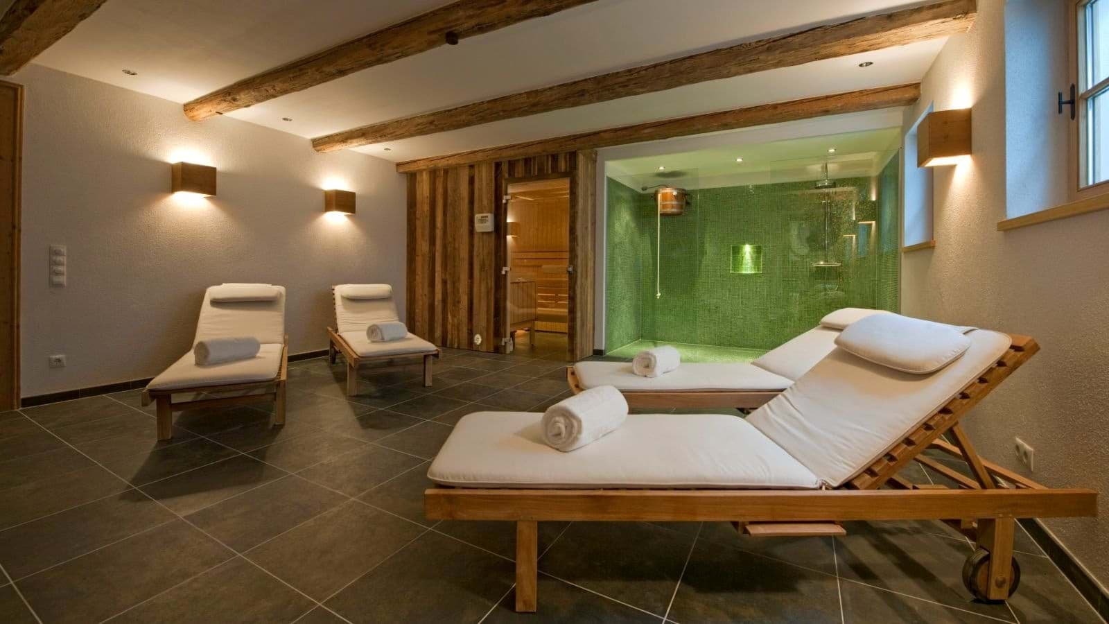 Private spa with wood-paneled sauna and cold plunge bucket shower