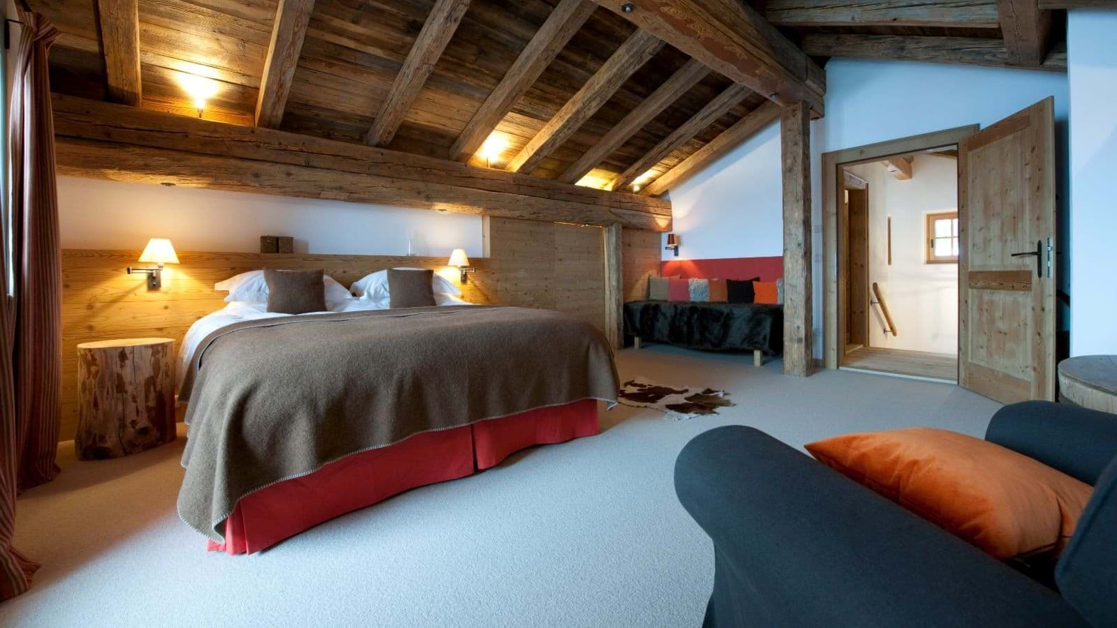 Top-floor bedroom with king bed and original exposed timber beams
