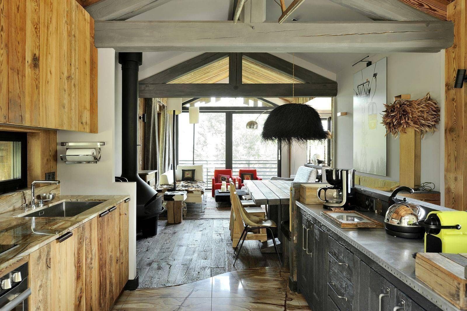 Open-plan kitchen and living area with wood-burning stove and balcony access