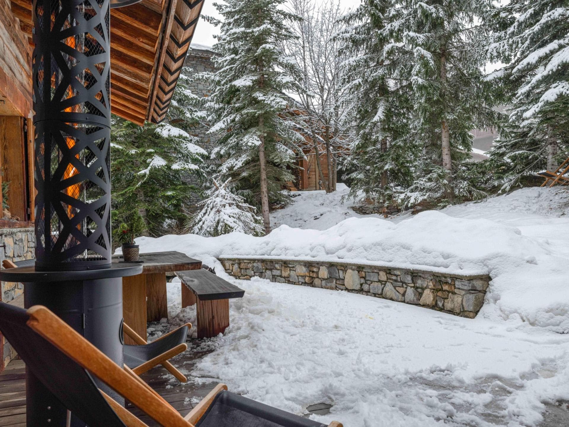 Patio with outdoor heater and wooden picnic table seating