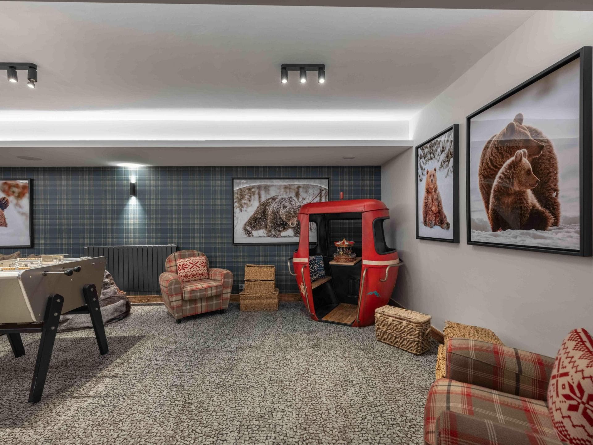 Game room with foosball table and repurposed ski gondola seating