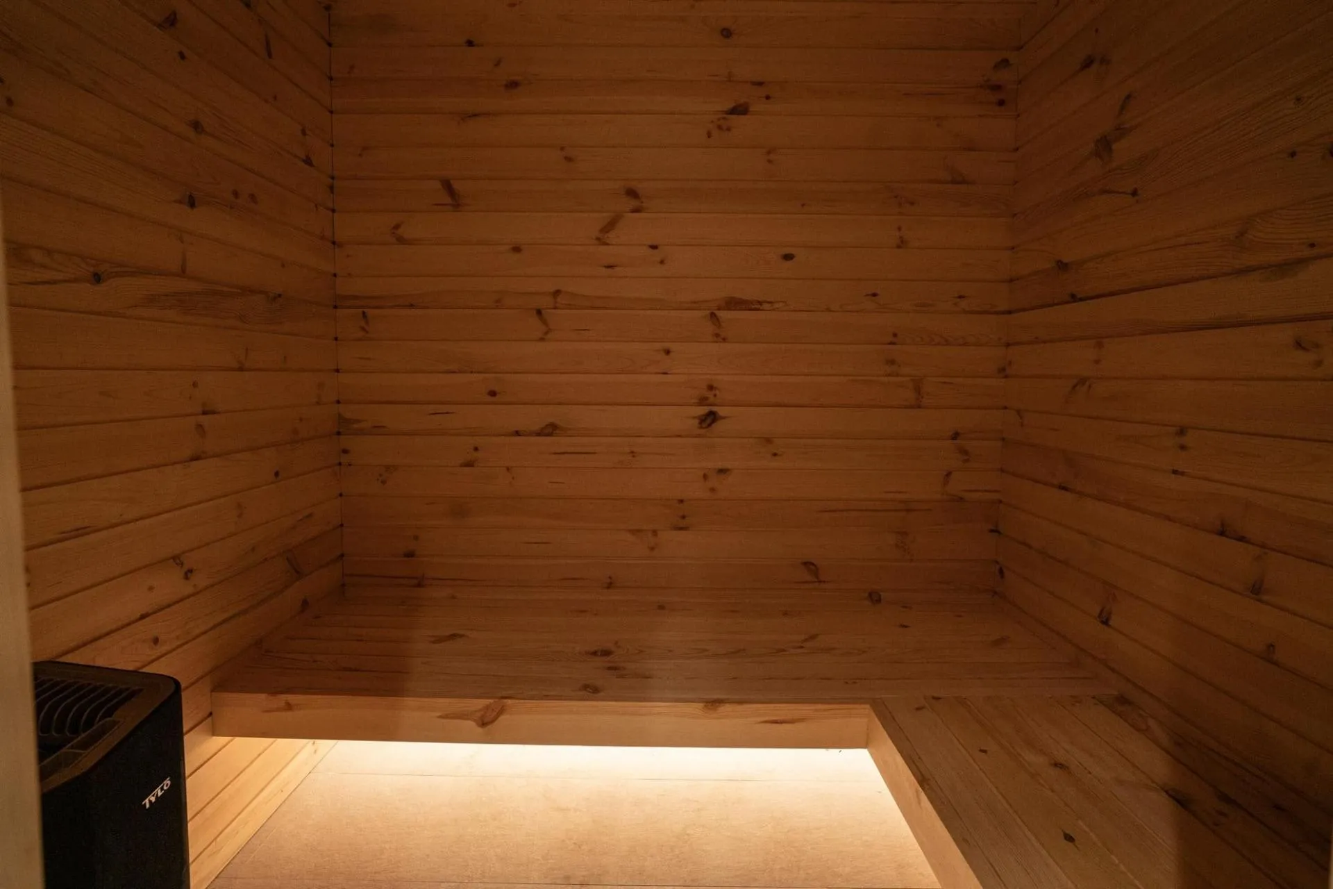 Wood-lined sauna with bench seating