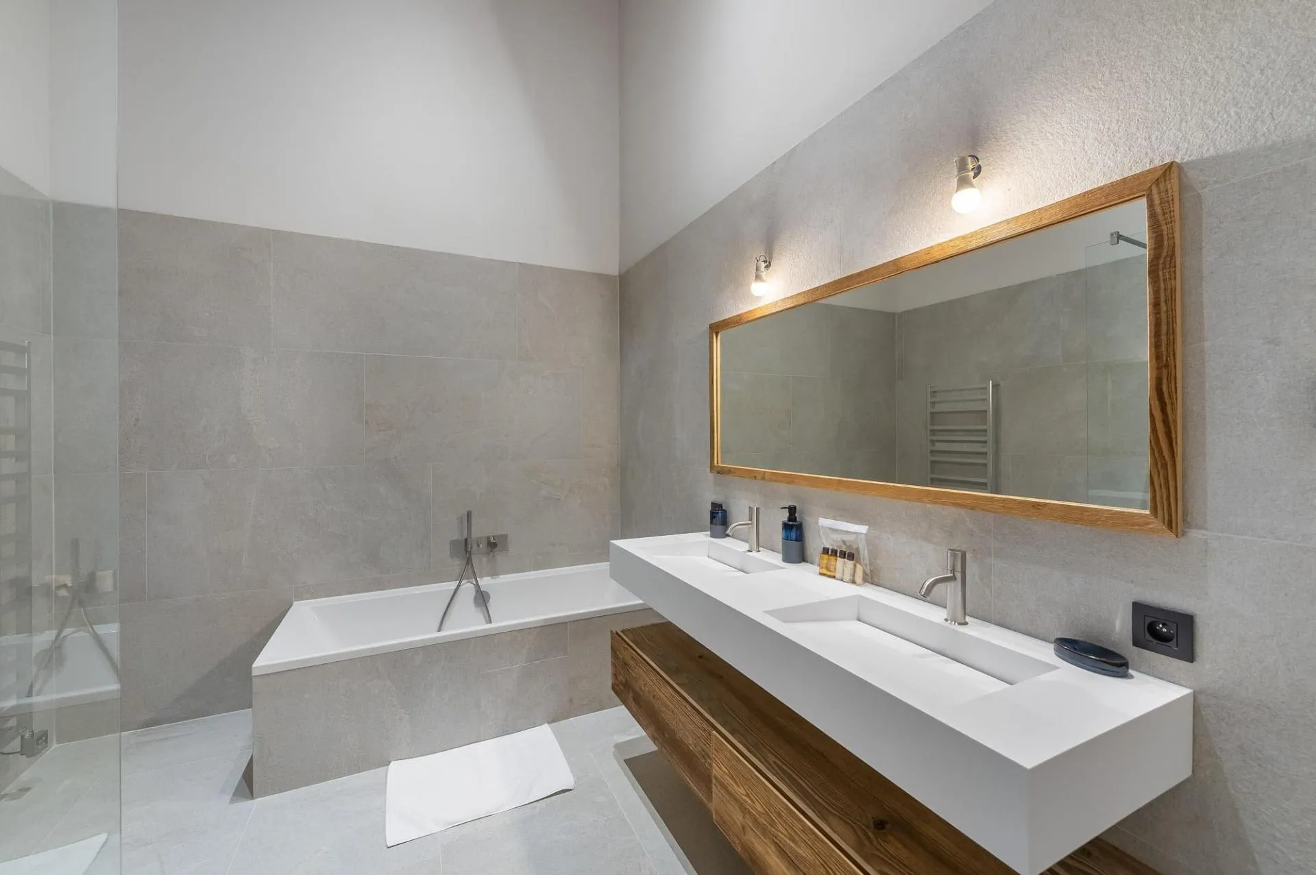 En-suite bathroom with twin basins and a bath