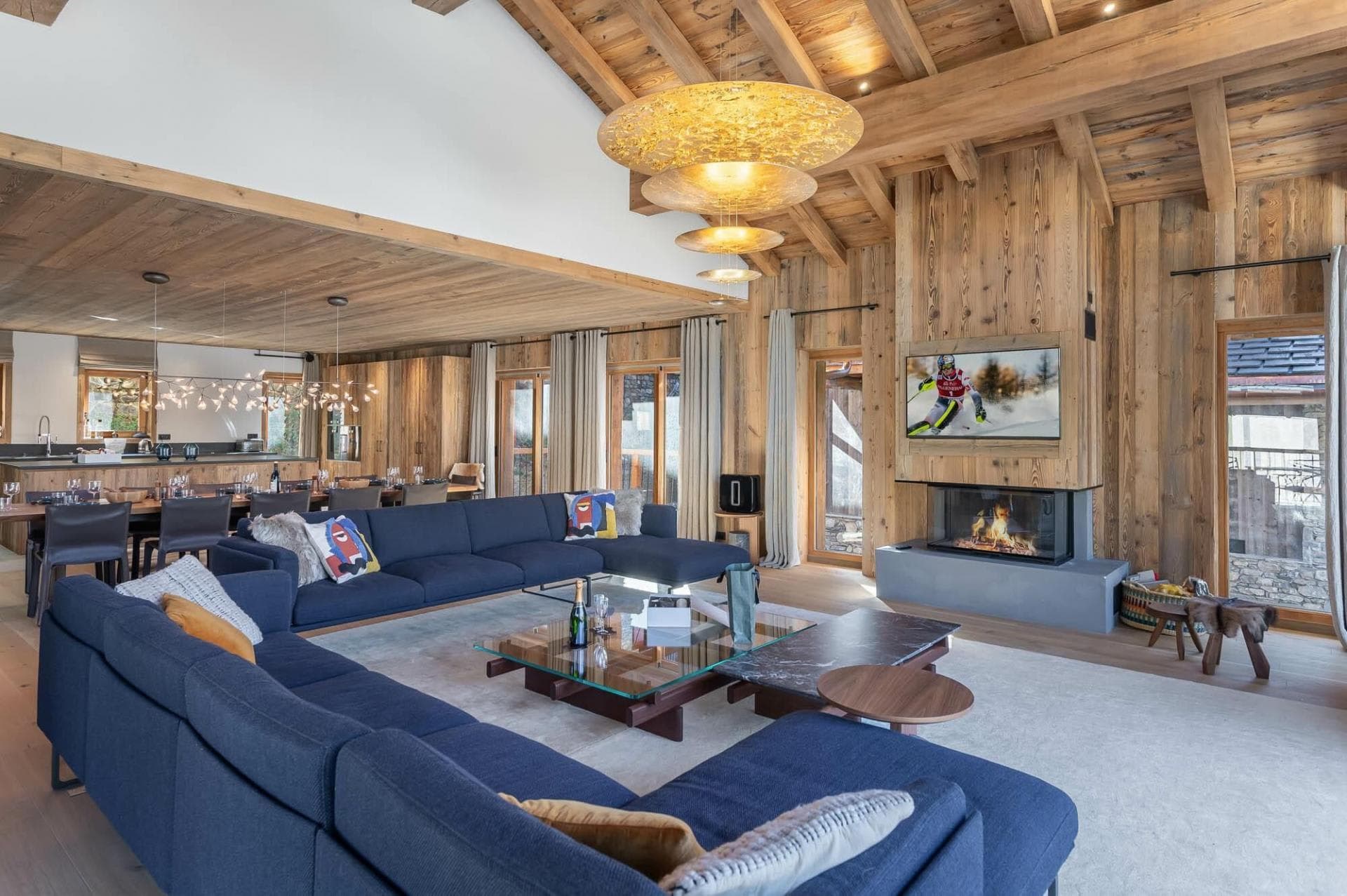 Open-plan living area with wood-burning fireplace and seating for 12