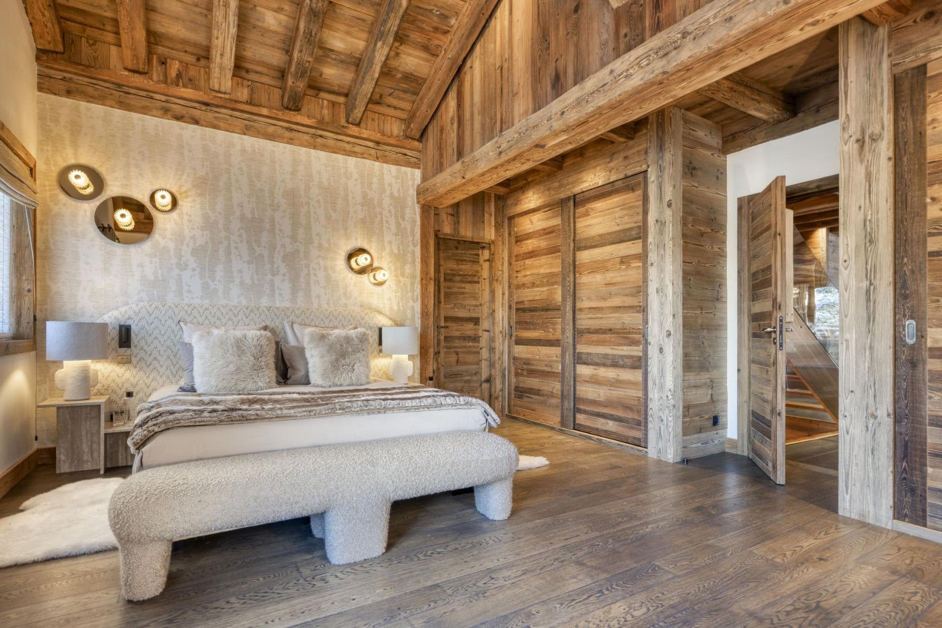 Primary bedroom with vaulted ceilings and integrated wood wardrobe storage