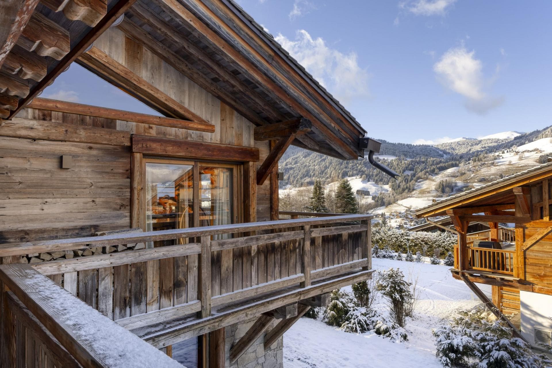 Private chalet balcony with sliding door access and mountain views