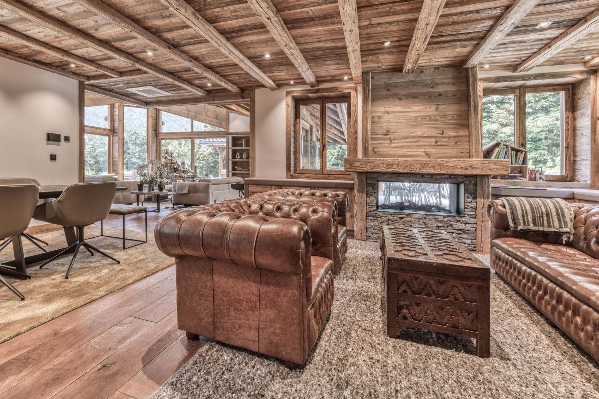 Living area with double-sided gas fireplace and leather Chesterfield seating