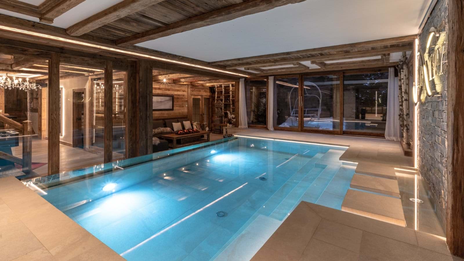 Indoor heated pool with integrated stone steps and lounge area