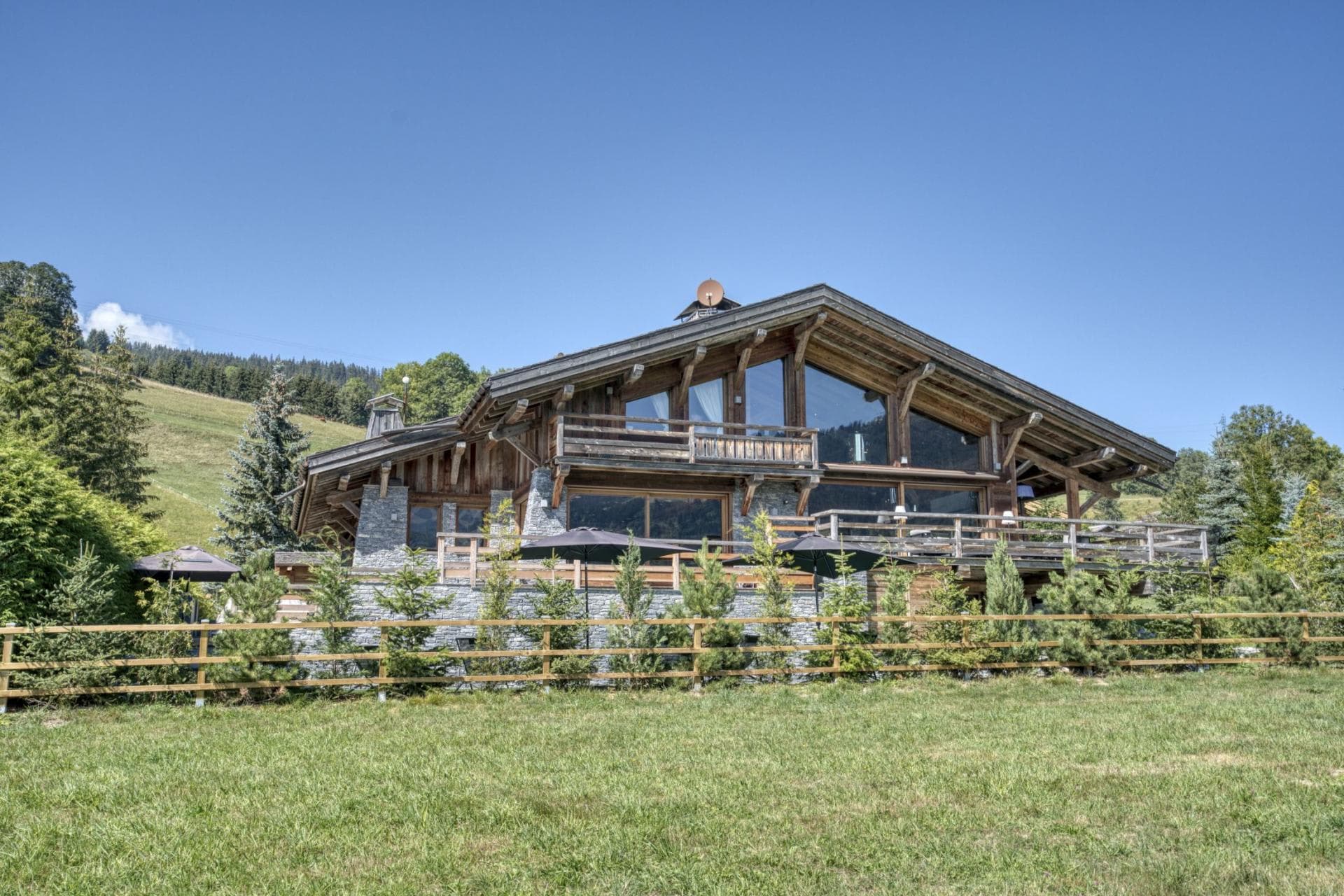 Chalet exterior with multi-level sun decks and privacy fencing
