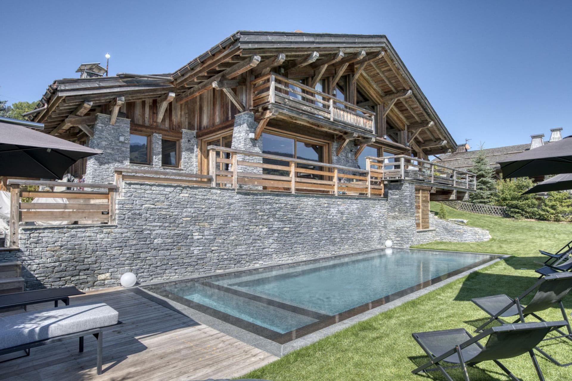 Stone-clad chalet with private lap pool and timber sun deck