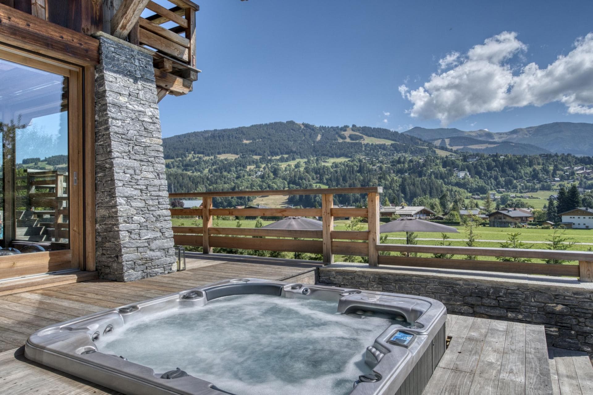Deck with recessed hot tub and views of the valley