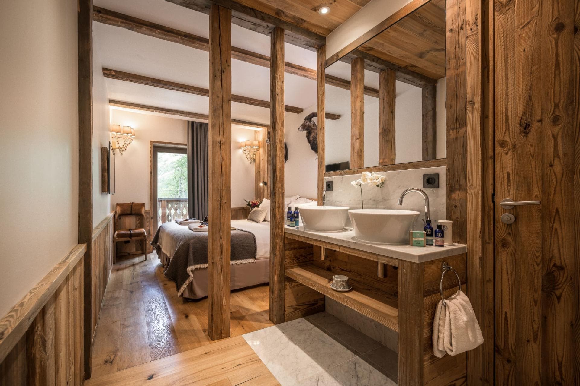 Open-plan ensuite with dual vanity and timber beam accents