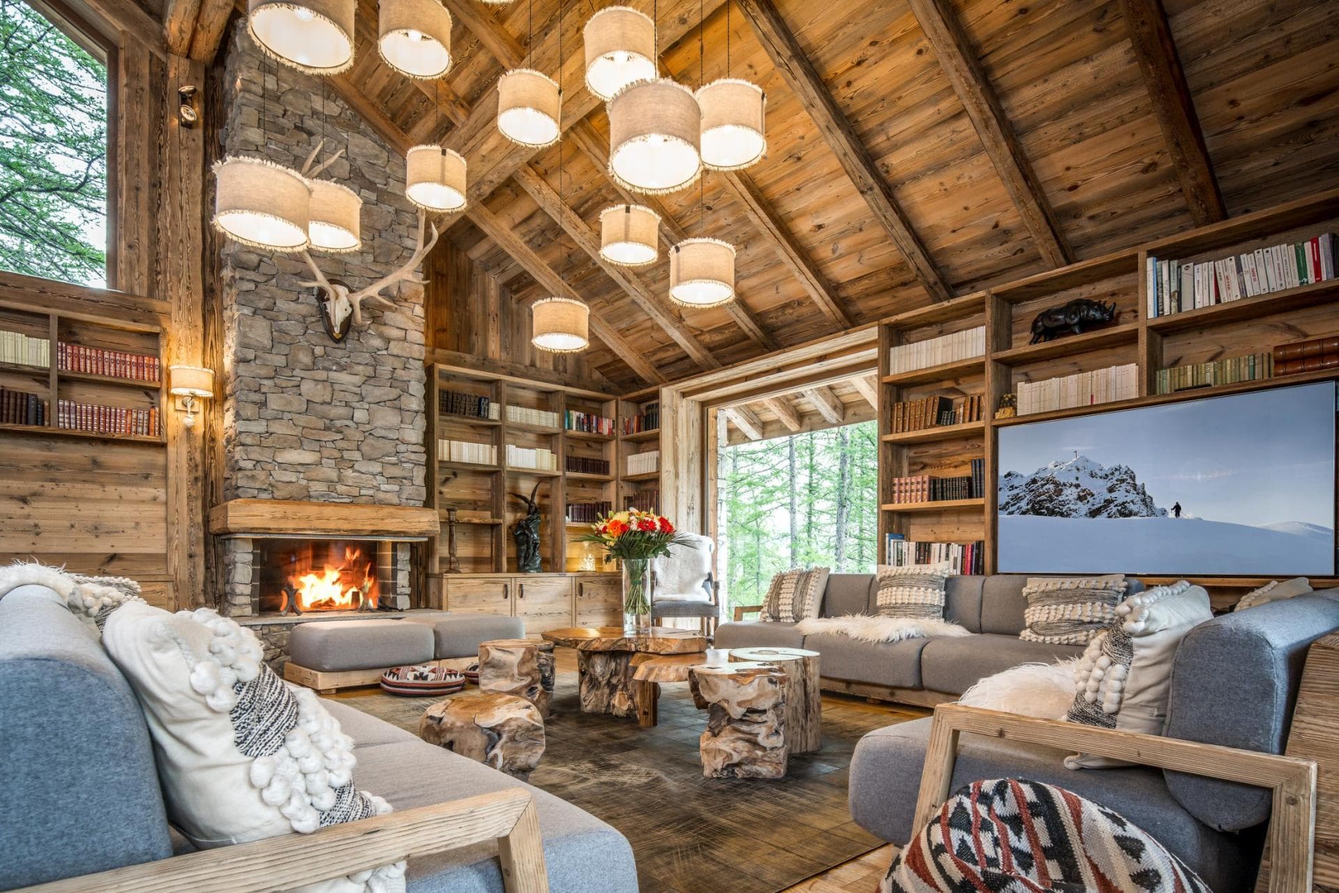 Living room with wood-burning fireplace and floor-to-ceiling bookshelves