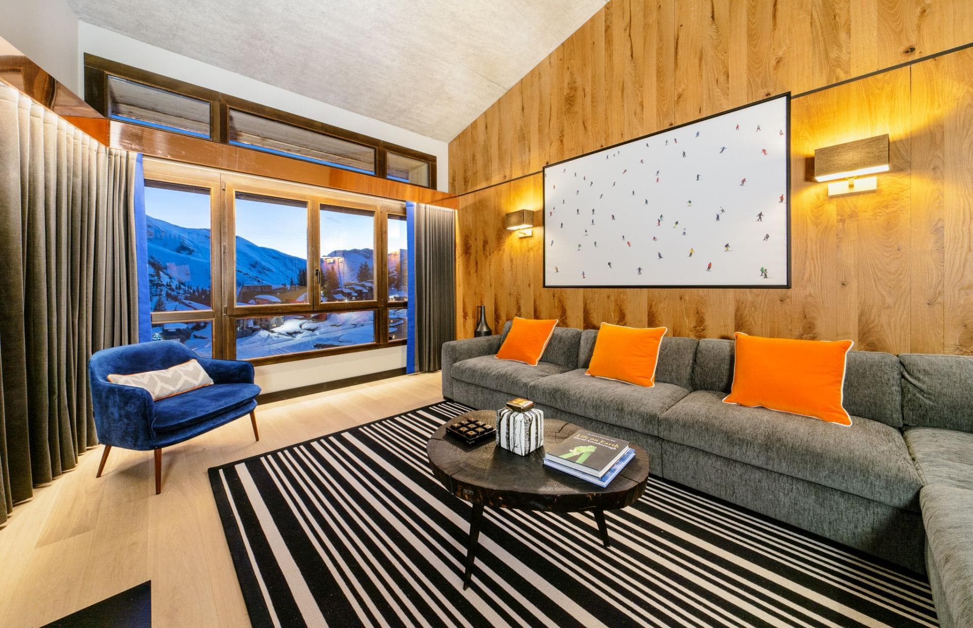 Living area with mountain views and wood-paneled walls
