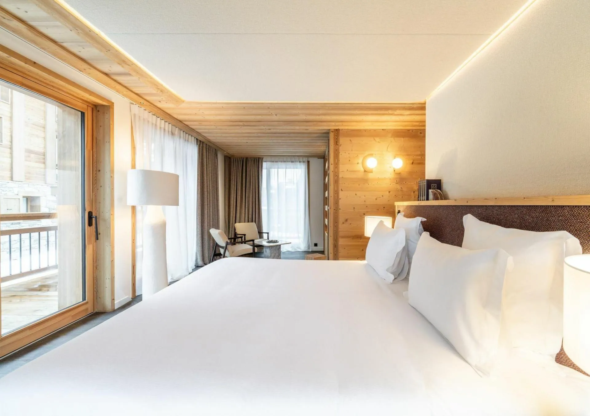 Double bedroom with balcony access and mountain views