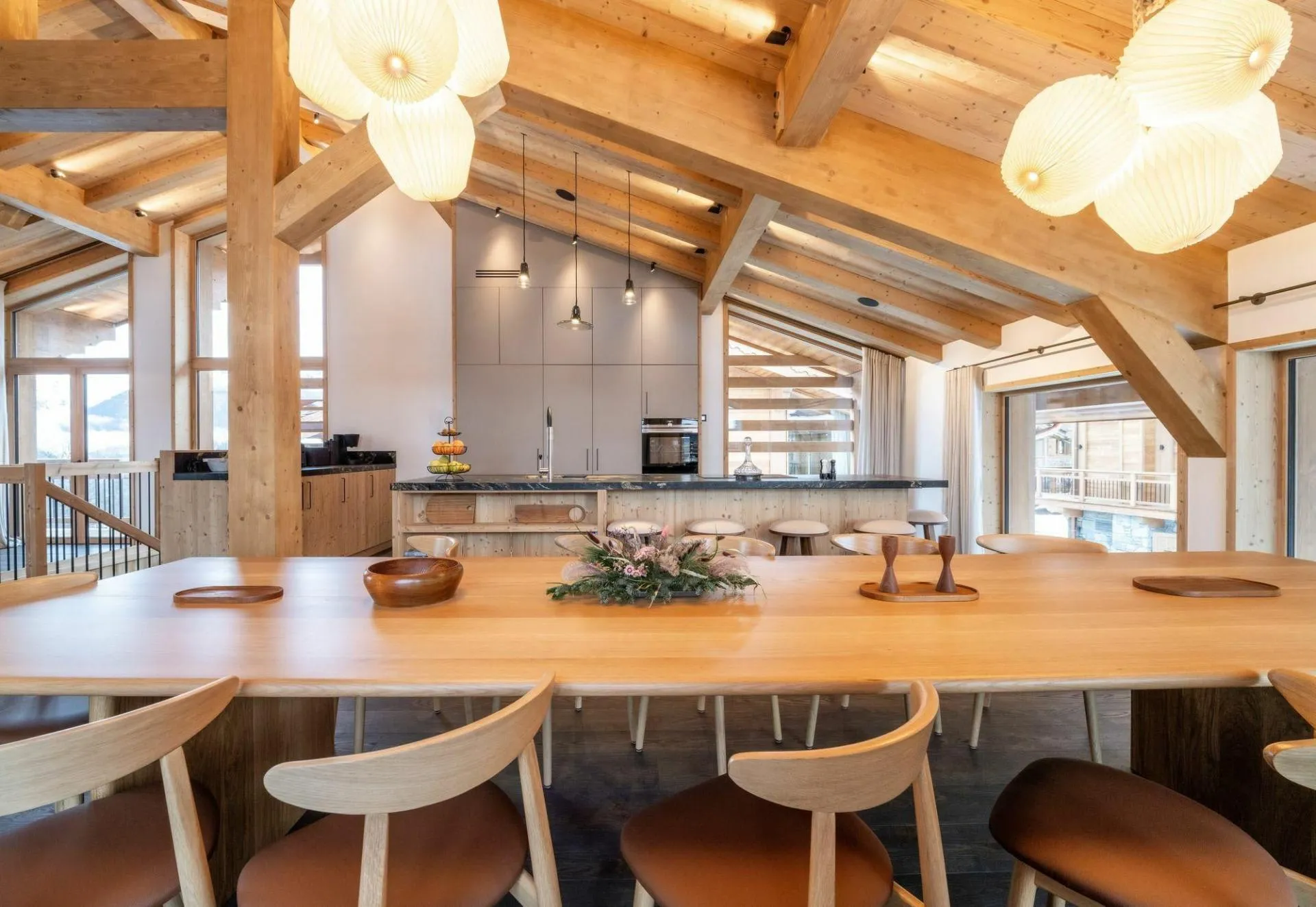 Dining area and open kitchen beneath timber ceilings