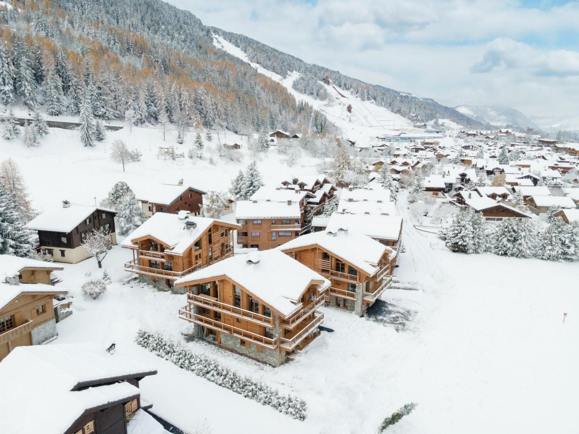 Aerial view of chalet village with ski-in/ski-out access and mountain views