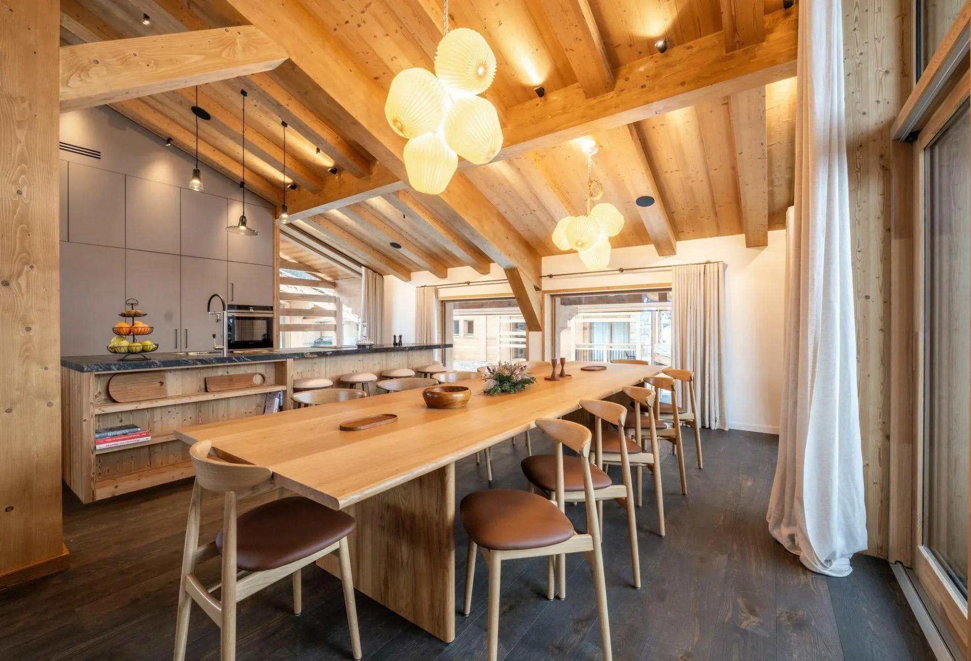 Dining table for ten beside the fitted kitchen
