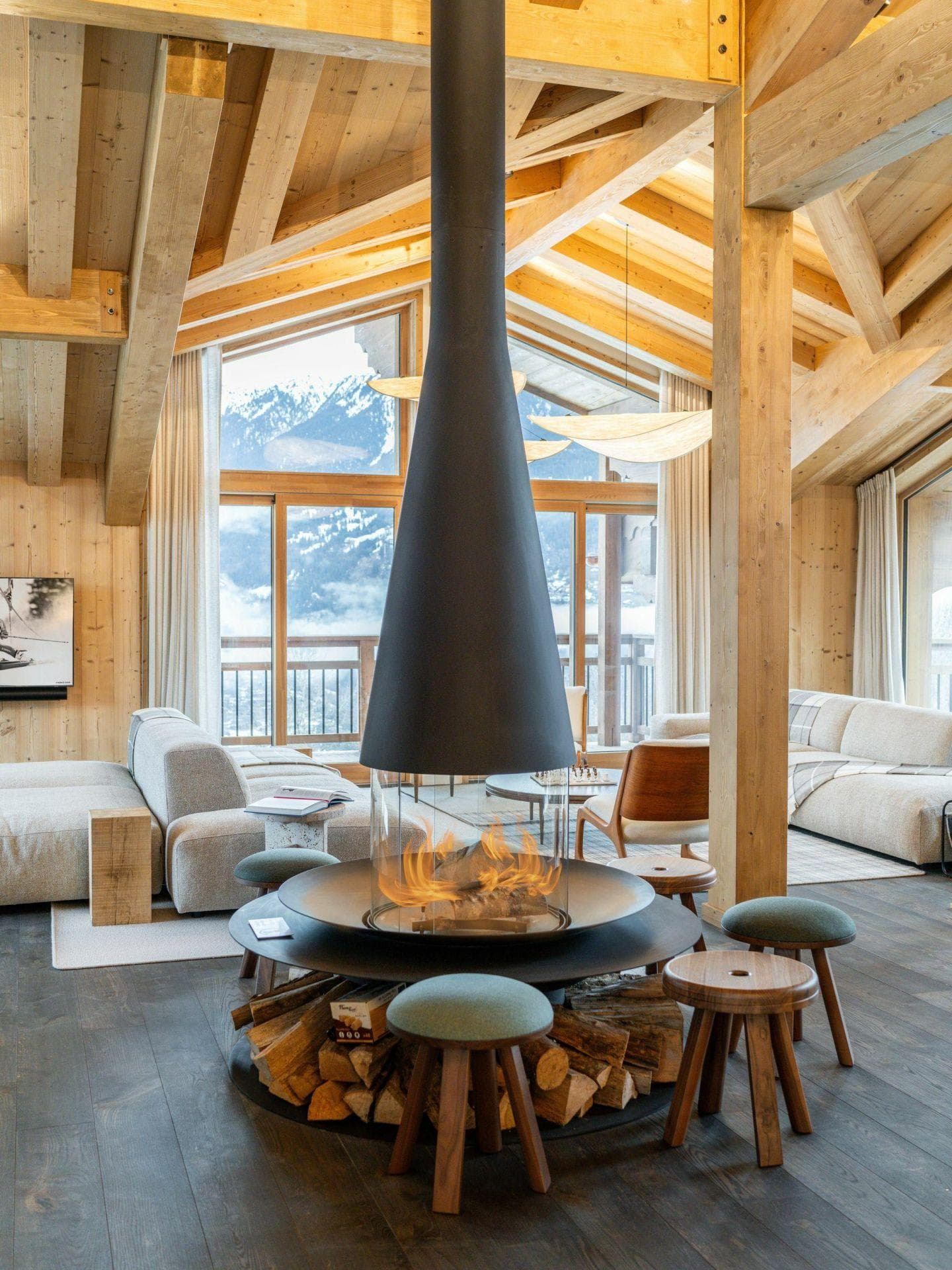 Central wood-burning fireplace with 360-degree glass and stool seating