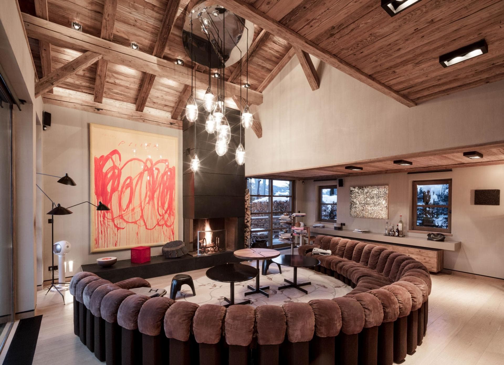 Living area with wood-burning fireplace and circular pit seating for 12