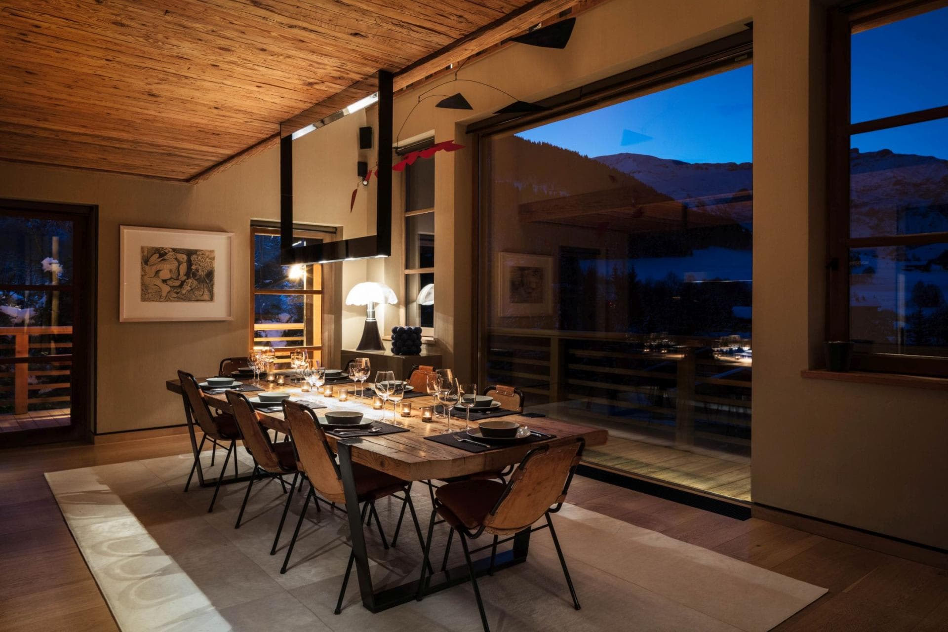 Dining area seating 8 with floor-to-ceiling windows and mountain views