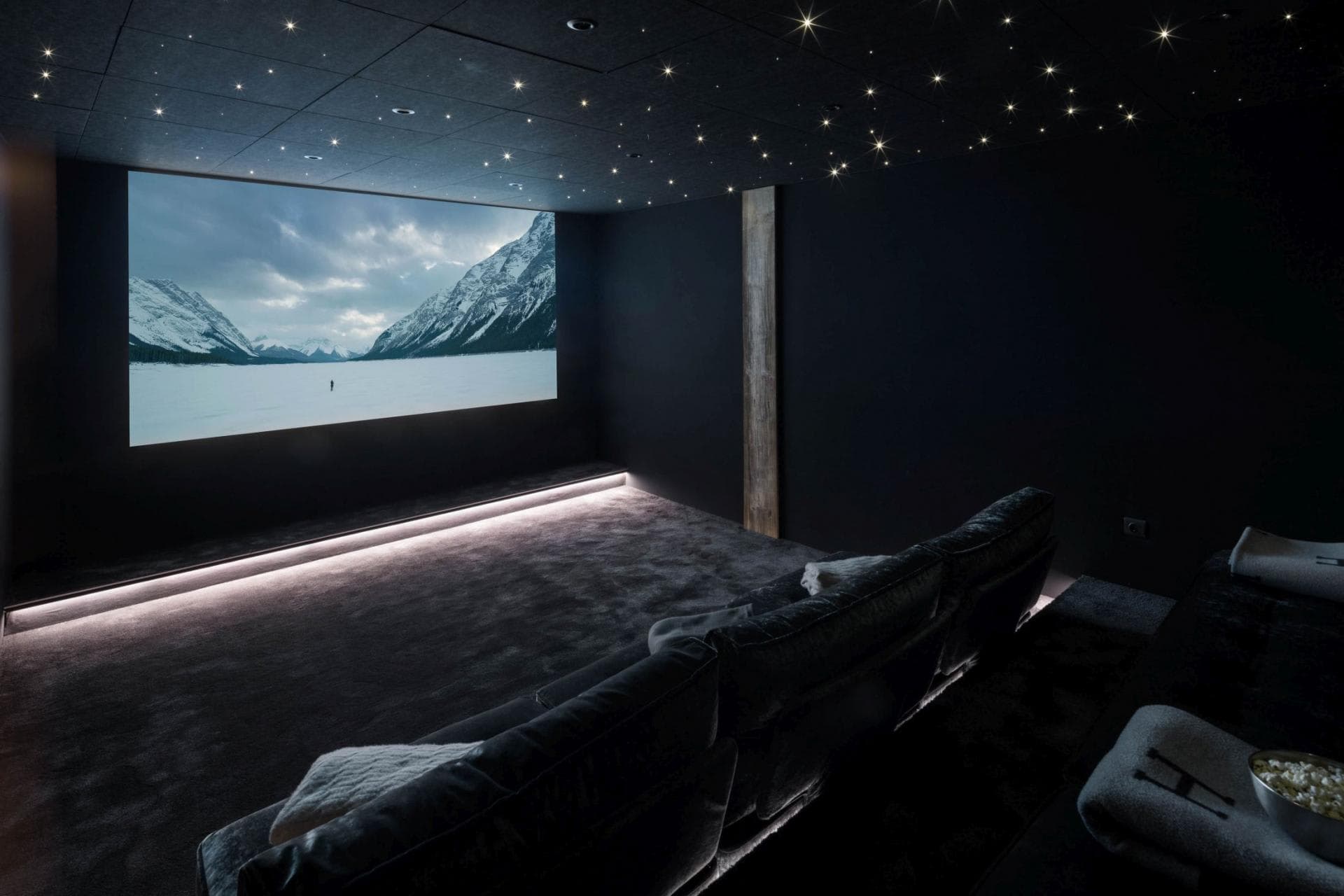 Private cinema with fiber optic starlight ceiling and projector screen