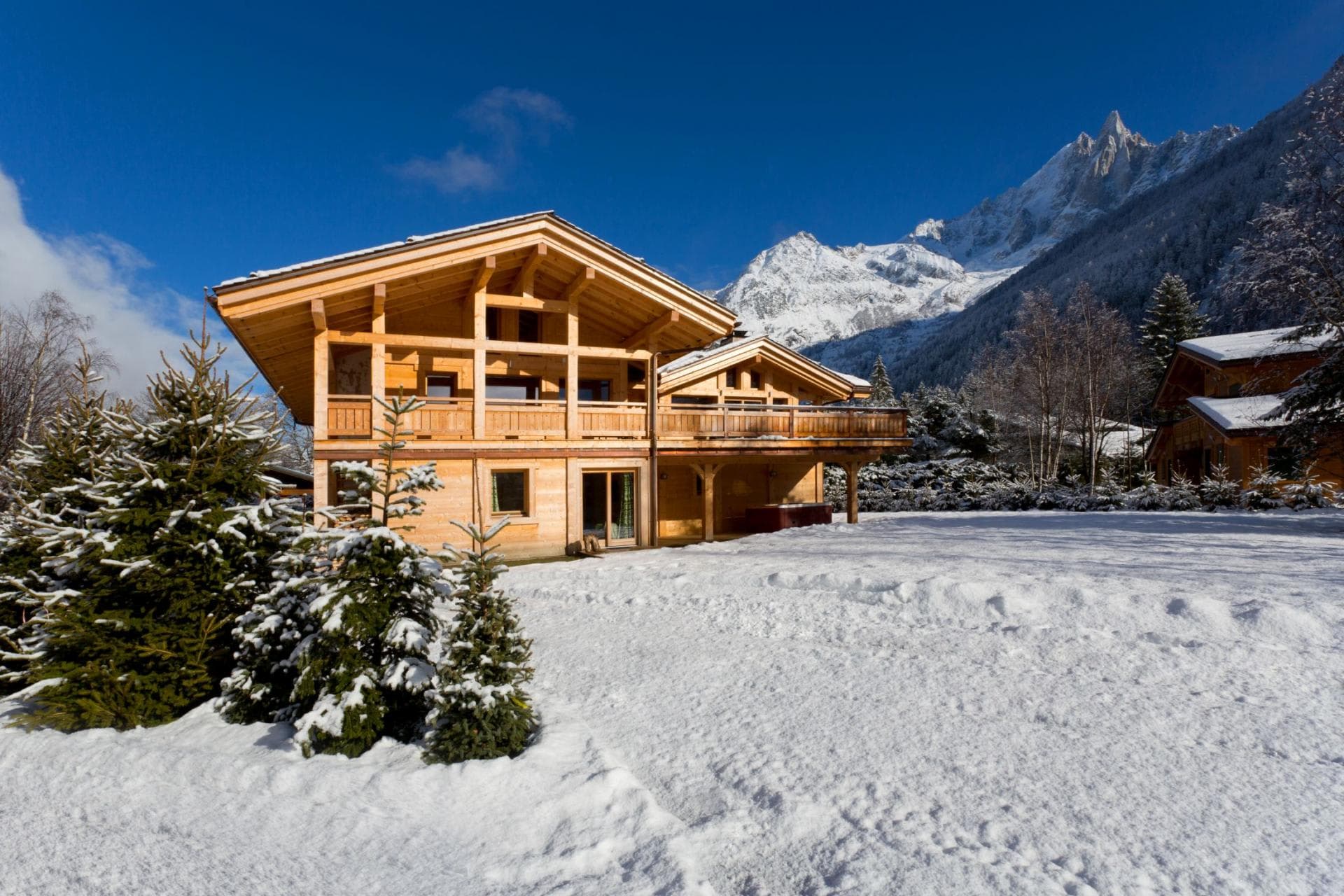 Chalet exterior with wrap-around balconies and private snow-covered yard